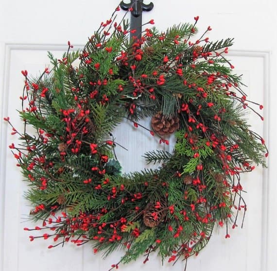 Christmas wreath with pinecones, red berries, and evergreen branches