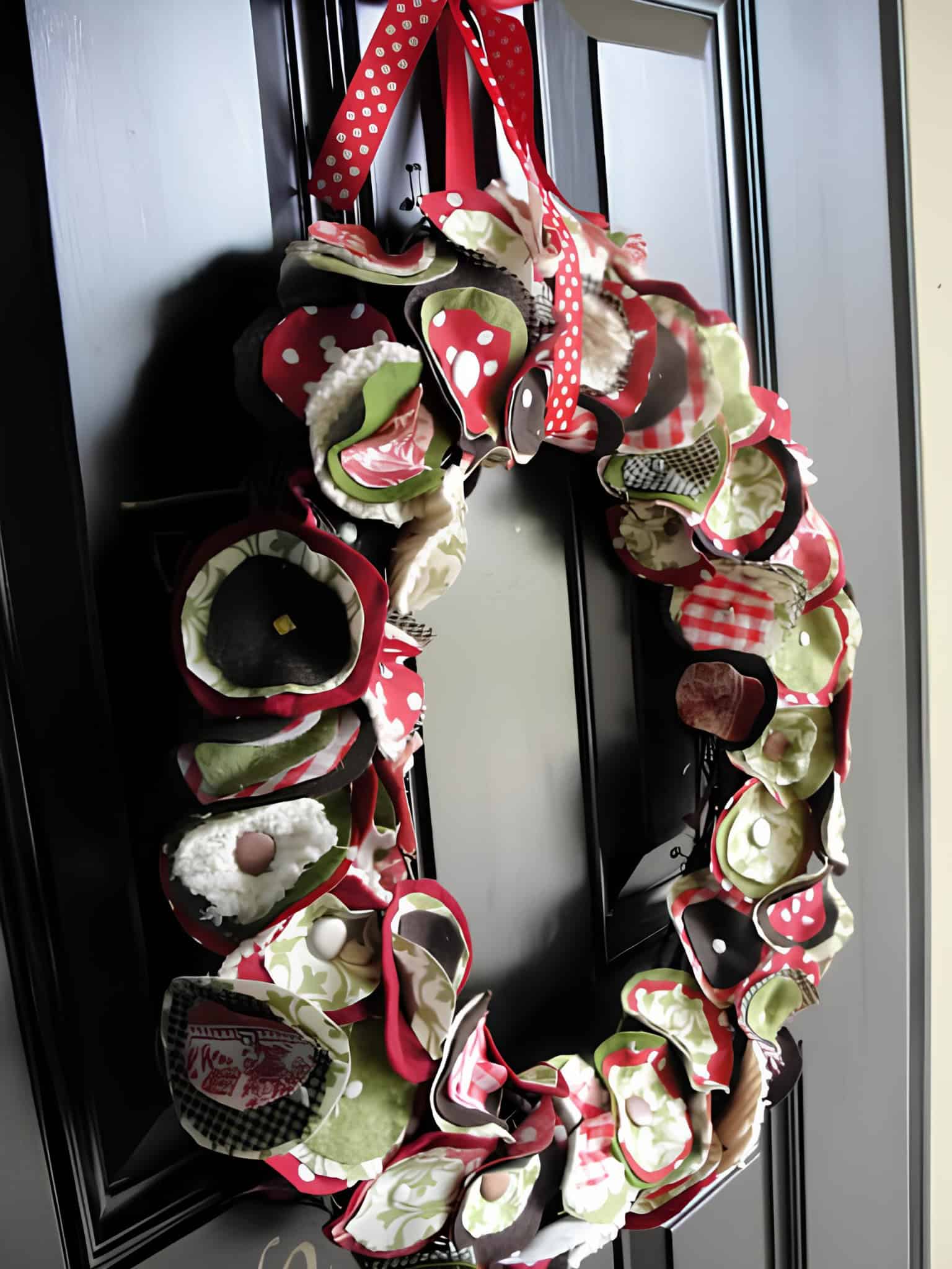 Handcrafted fabric-and-ribbon loop wreath in red, green and cream tones