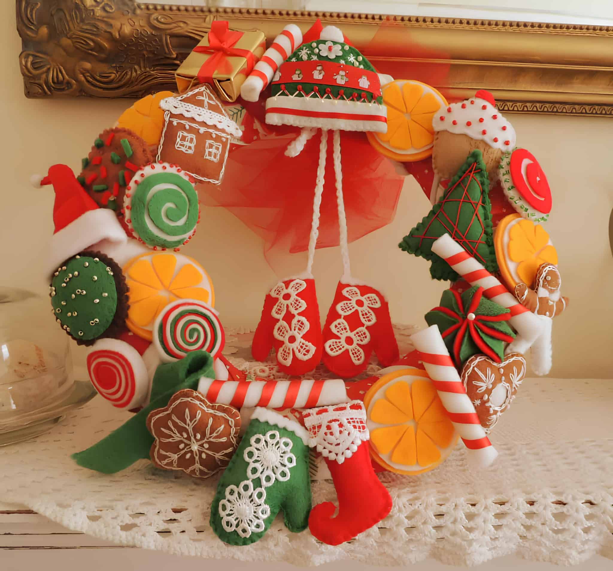 Colorful handmade Christmas wreath made with felt candies and gingerbread shapes