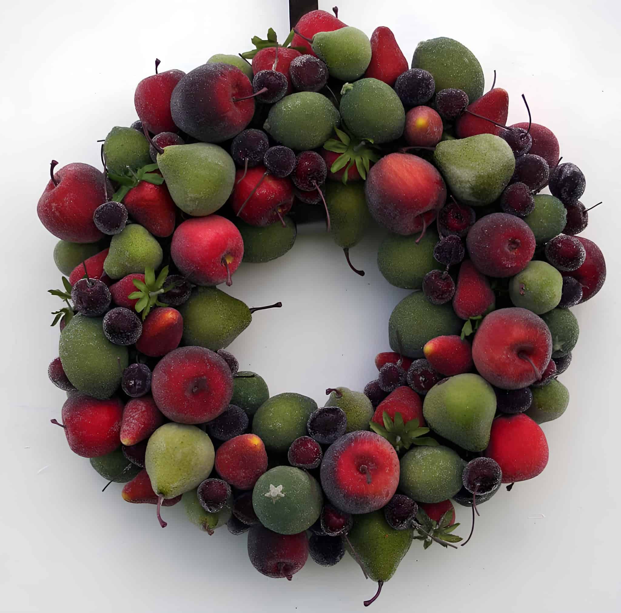 Classic Christmas wreath covered with frosted apples, pears and berries