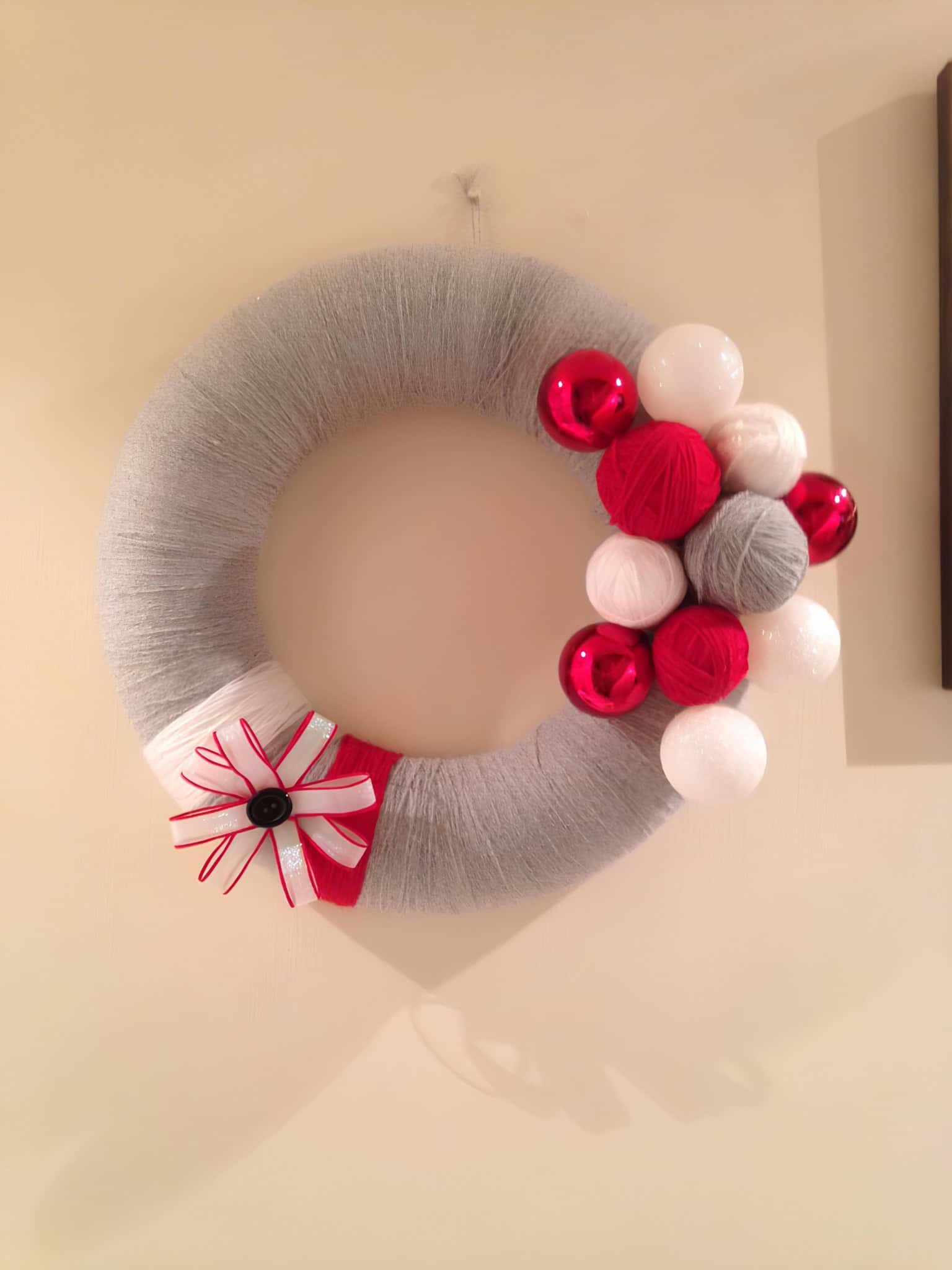 Cozy gray yarn-wrapped wreath with red and white ornament balls