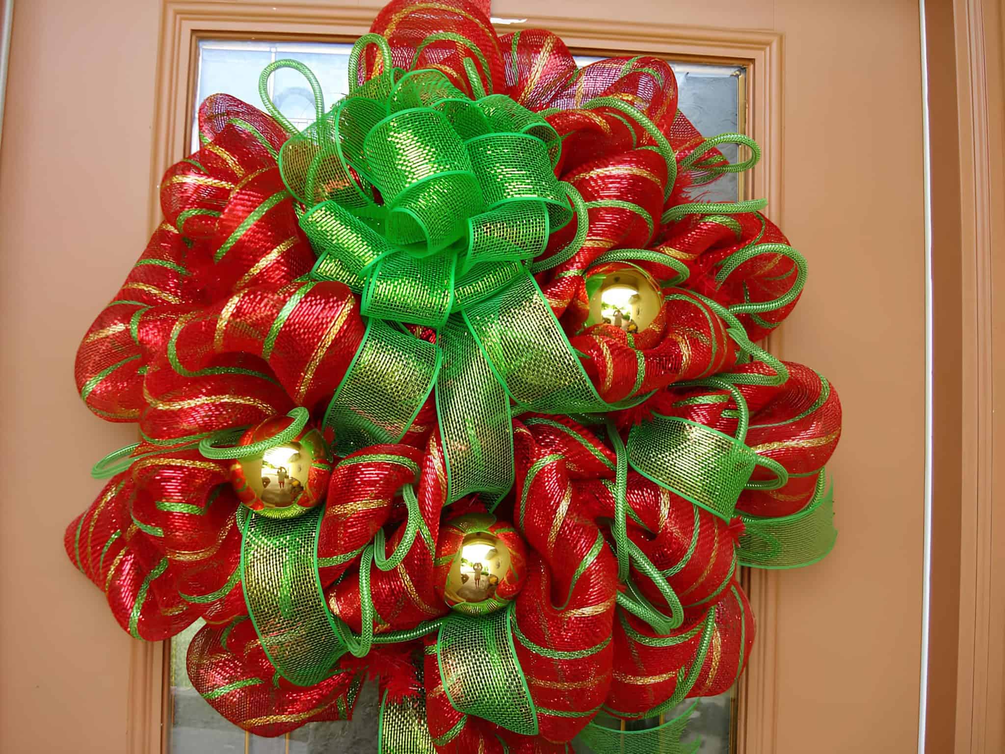 Green and red mesh Christmas wreath with gold ornaments