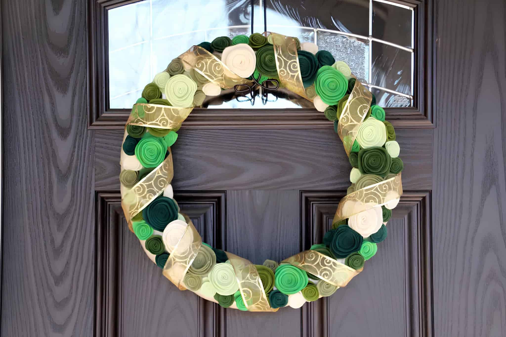 Christmas wreath made of rolled felt rosettes wrapped with gold ribbon