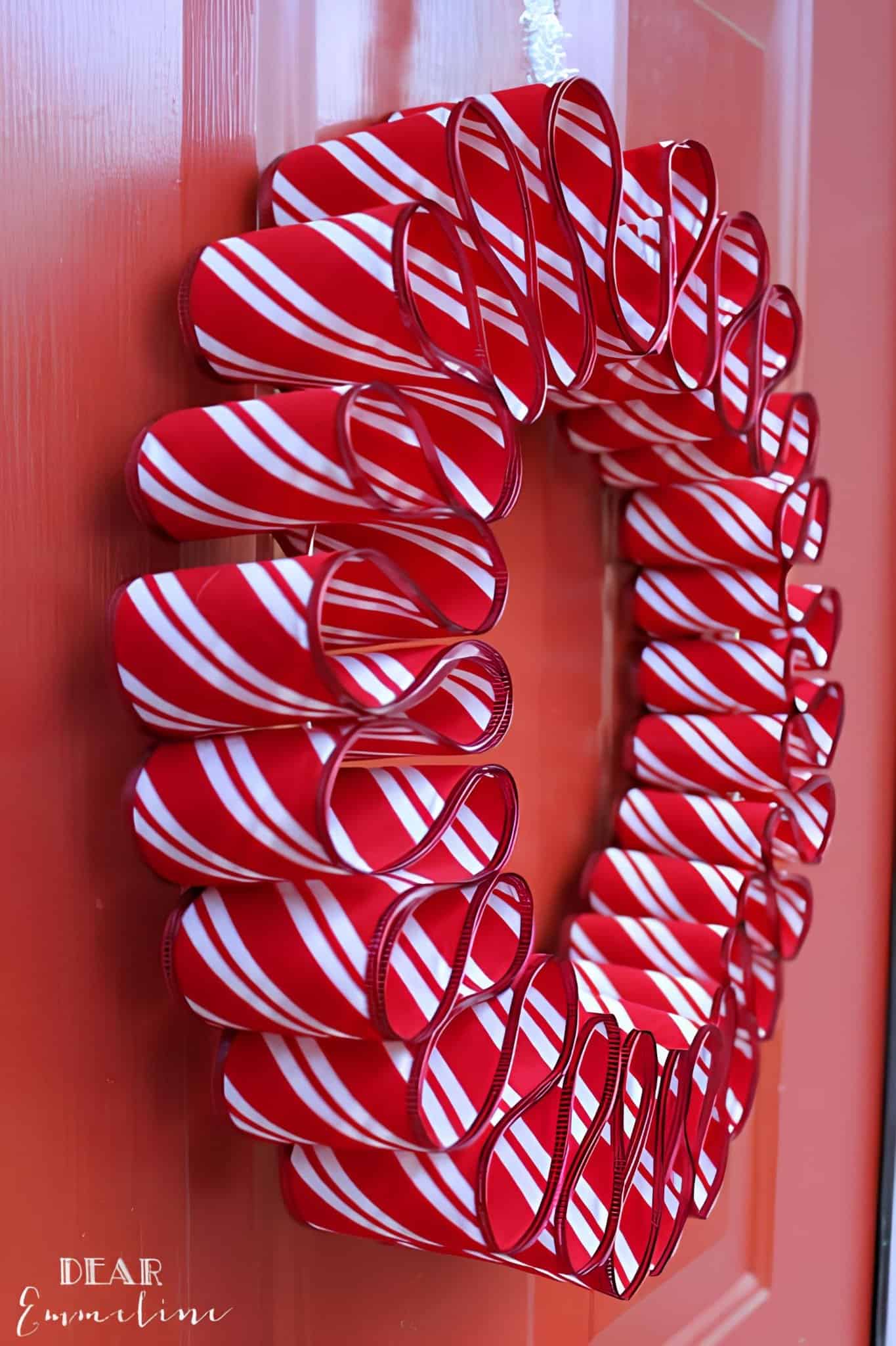 Greenery Christmas wreath with a wooden sign that says Merry Christmas