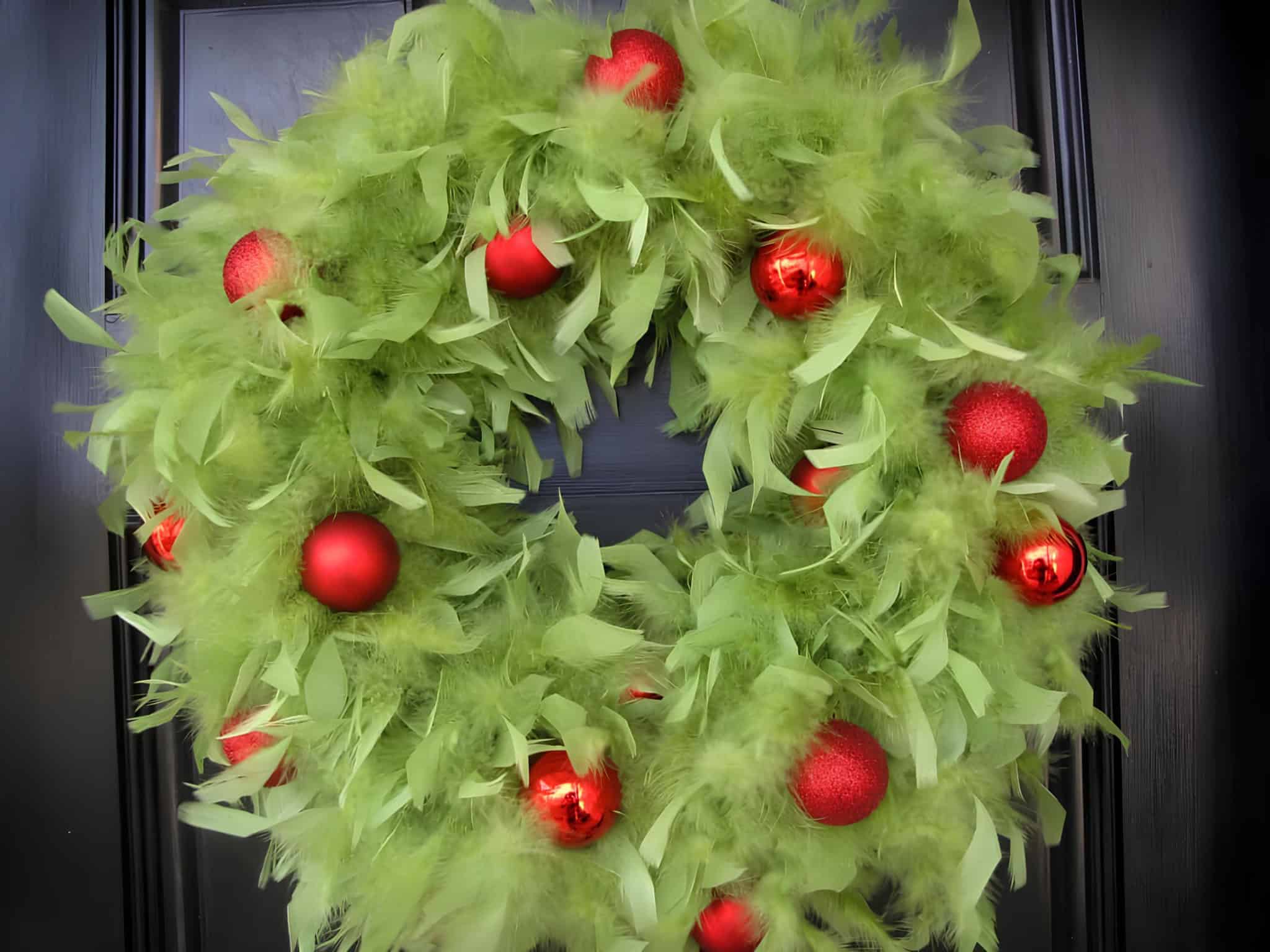 Green feather Christmas wreath with red ornaments