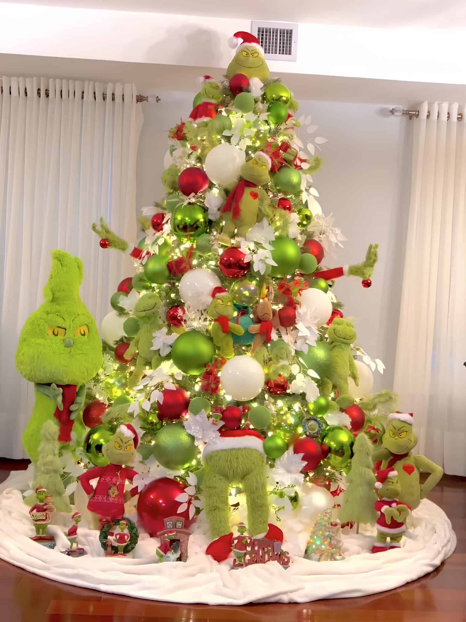 Playful Grinch-themed Christmas tree with plush toys, green ornaments, and whimsical details