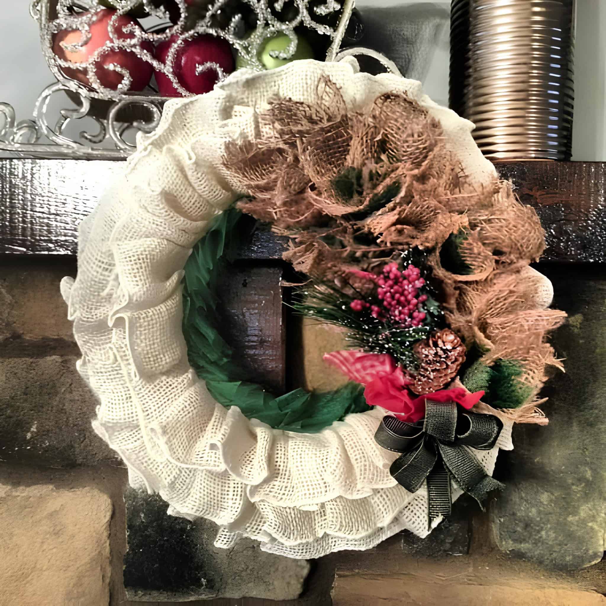 Two-tone burlap wreath with red bow, pinecones and berries