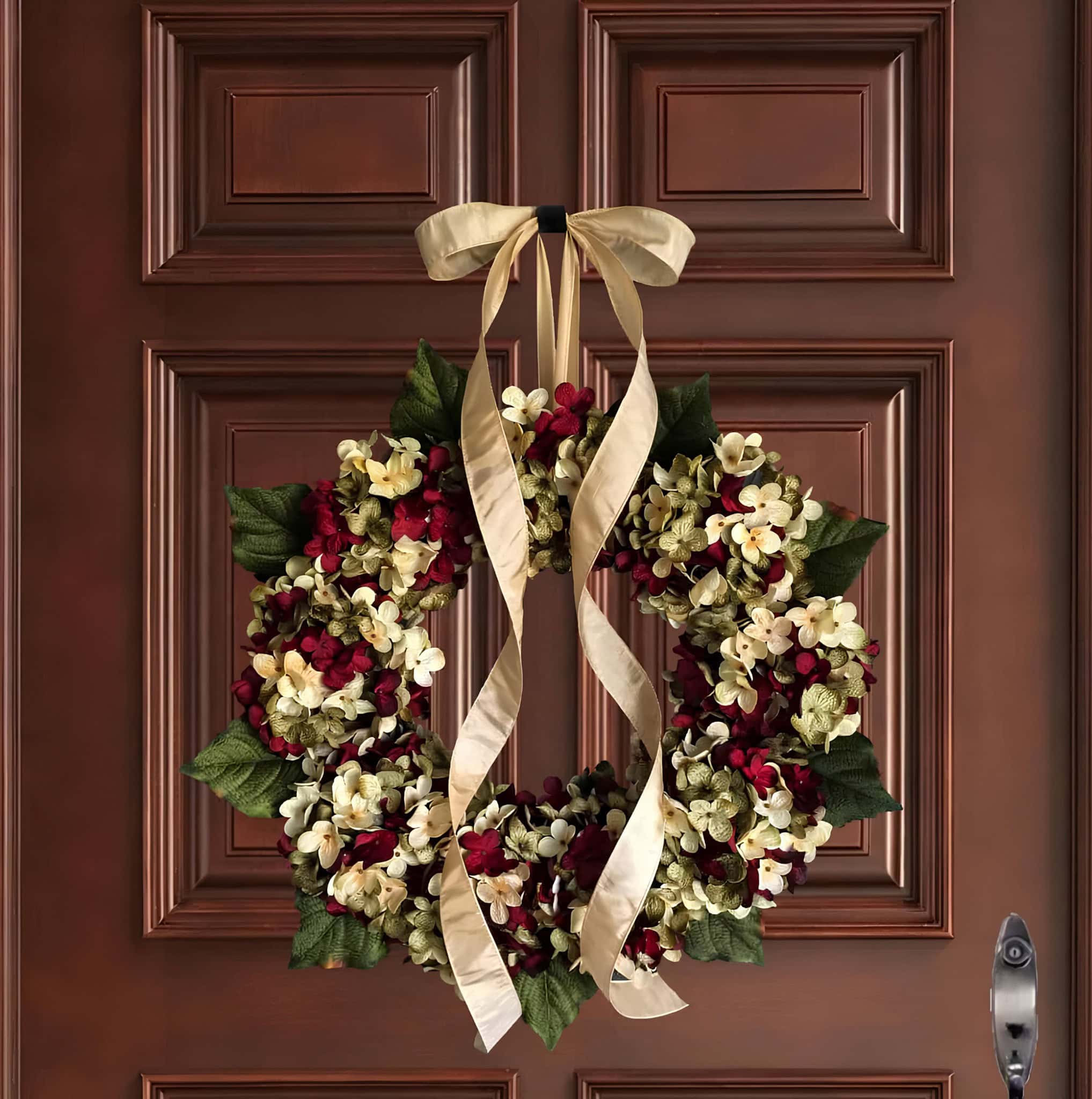 Floral Christmas wreath of red and ivory hydrangeas with long gold ribbon bow