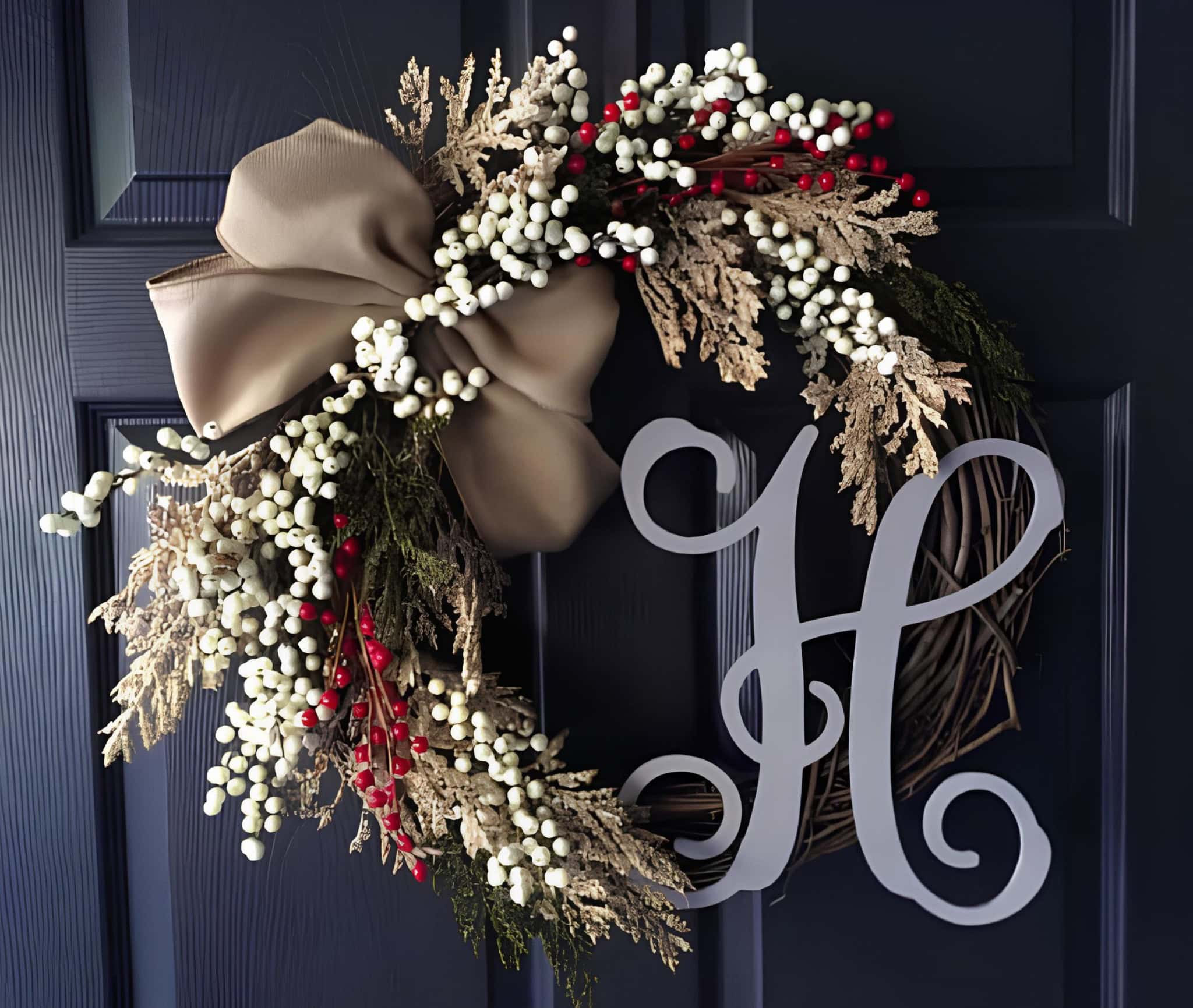 Elegant wreath with large taupe bow, white berries, delicate foliage and a script initial H