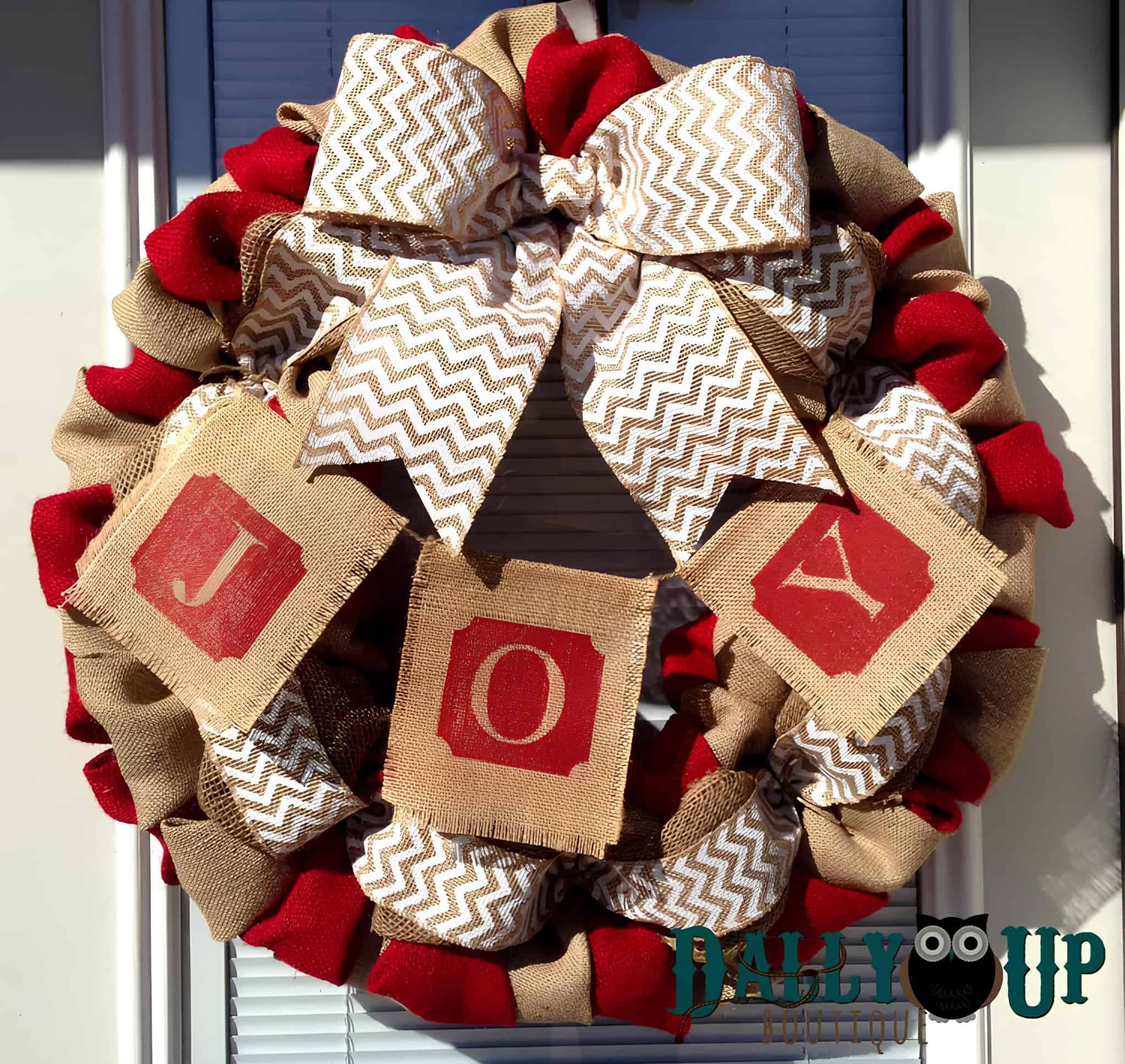 Burlap and red ribbon wreath with chevron bow and JOY banner blocks
