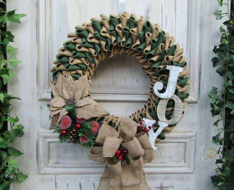 Burlap Christmas wreath with greenery, poinsettias, and JOY letters