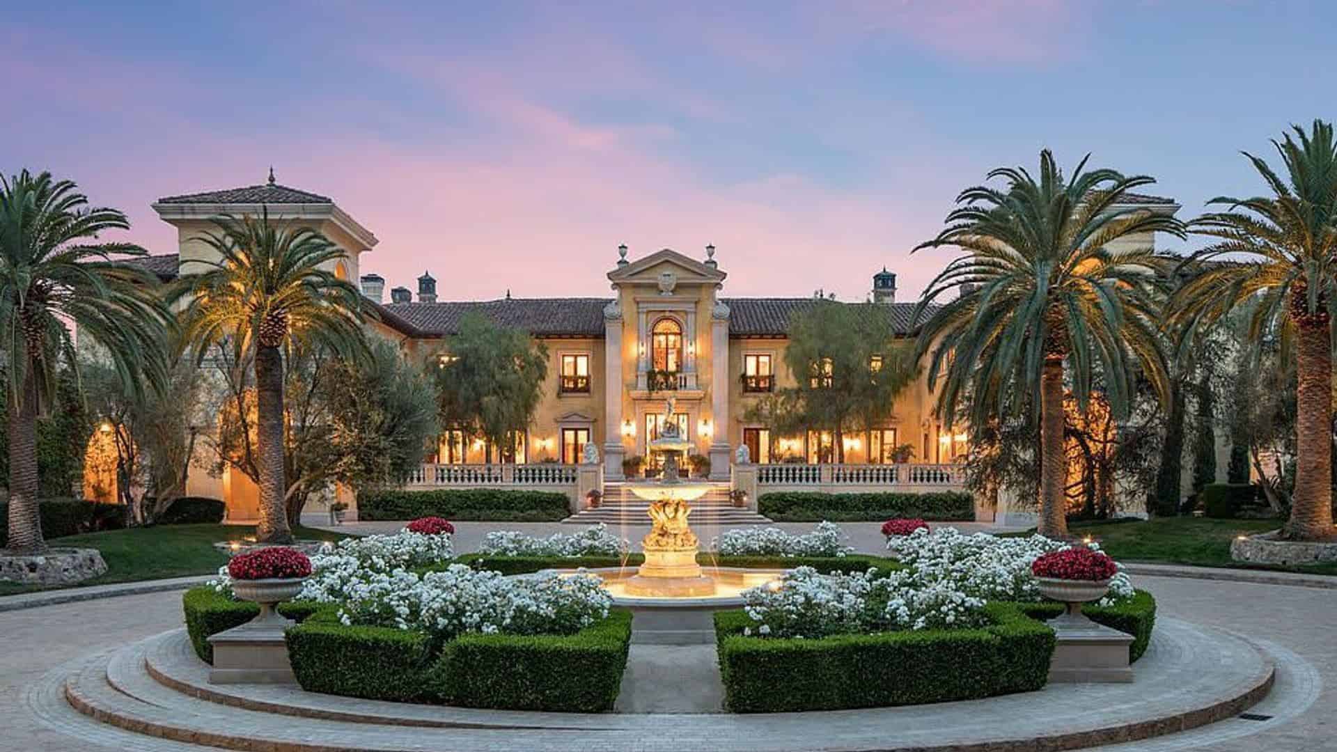 Elegant luxury mansion interior with marble flooring, grand staircase, and chandelier showing high-end construction costs 2025