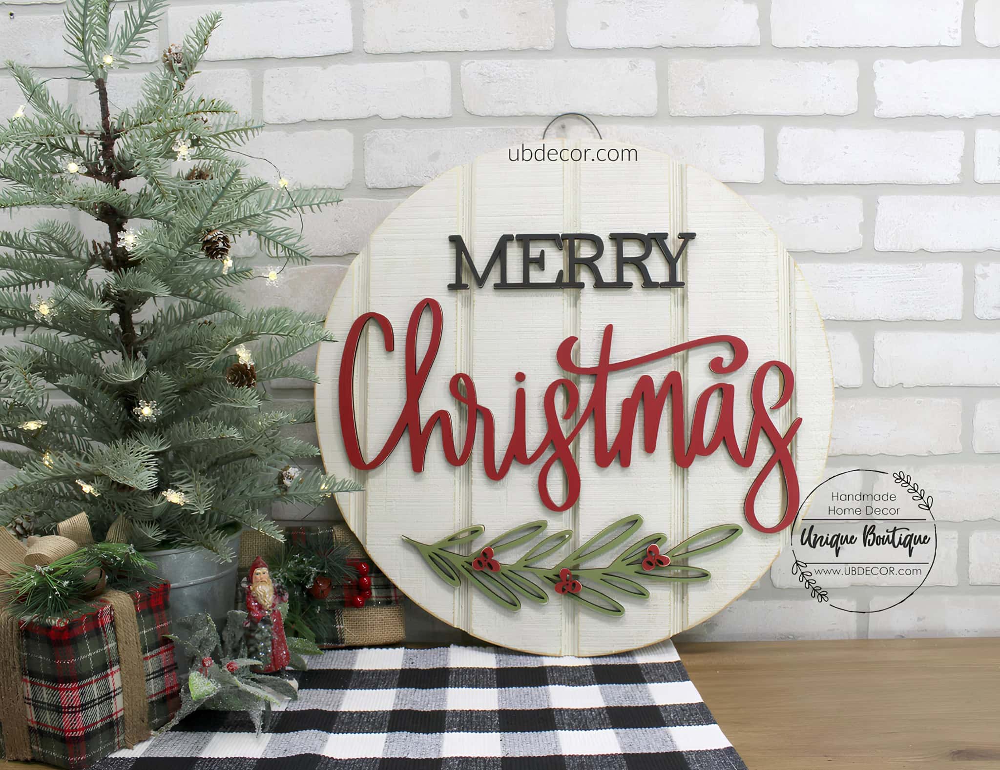 Round wood door sign with layered Merry Christmas lettering and holly