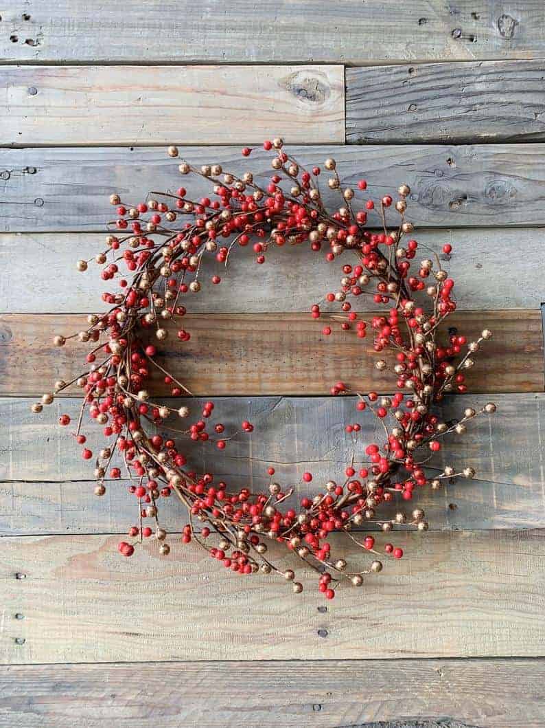 Rustic red berry wreath on wooden background