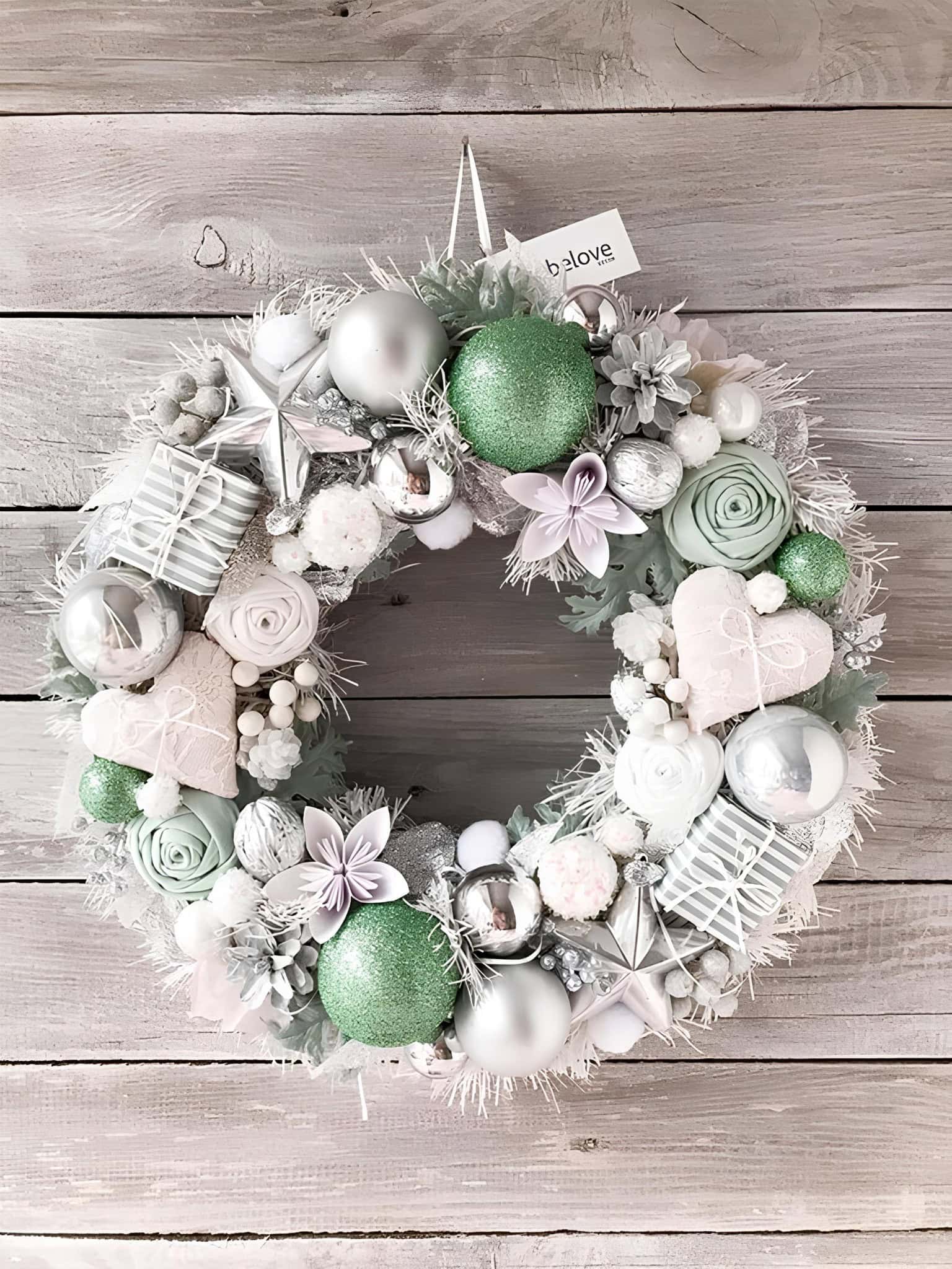 Mint and silver Christmas wreath with floral accents and ornaments
