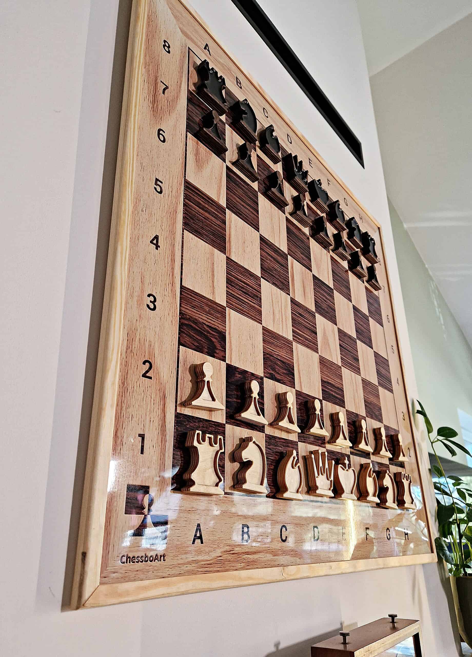 Dynamic perspective of a large vertical chess board by ChessboArt, integrated into an architectural space, emphasizing its sculptural presence and scale.