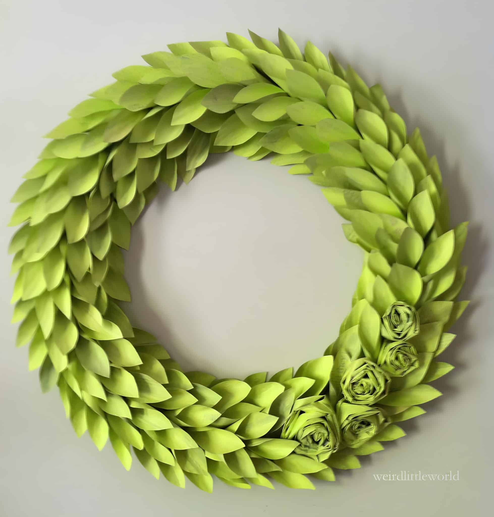 Handmade paper leaf wreath in light green color with flower accents