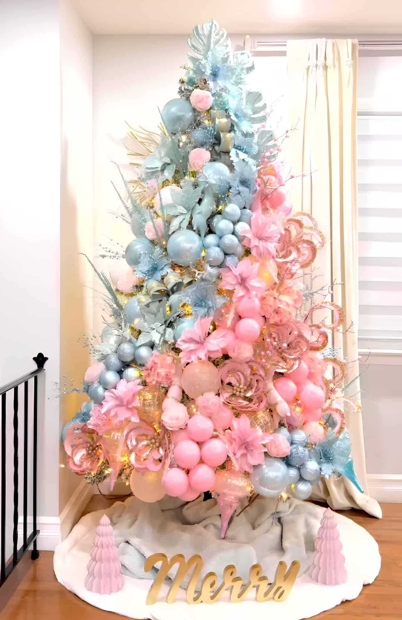 Pastel pink and blue Christmas tree with floral ornaments and metallic accents