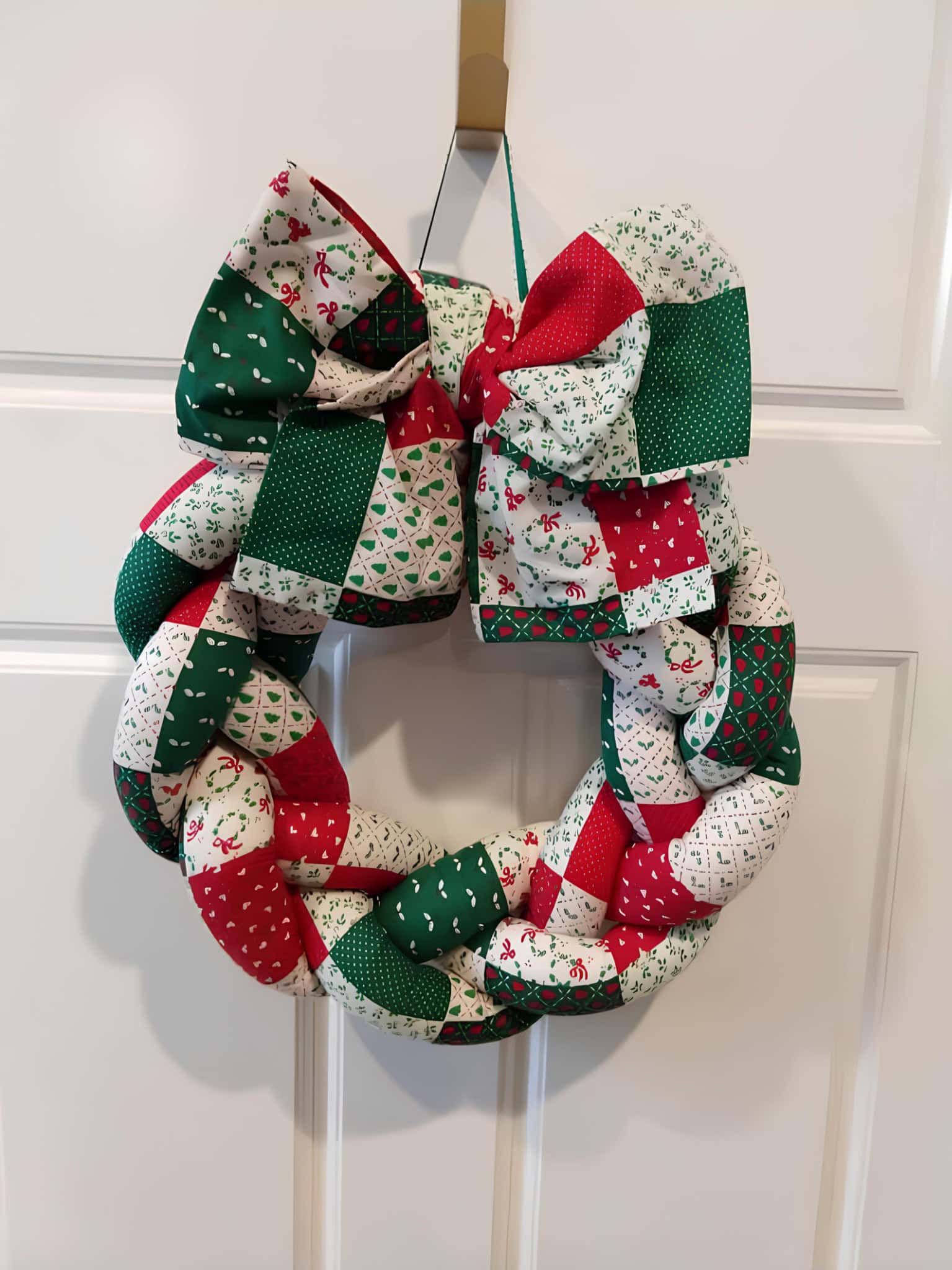 Quilted patchwork braided Christmas wreath with a big matching bow