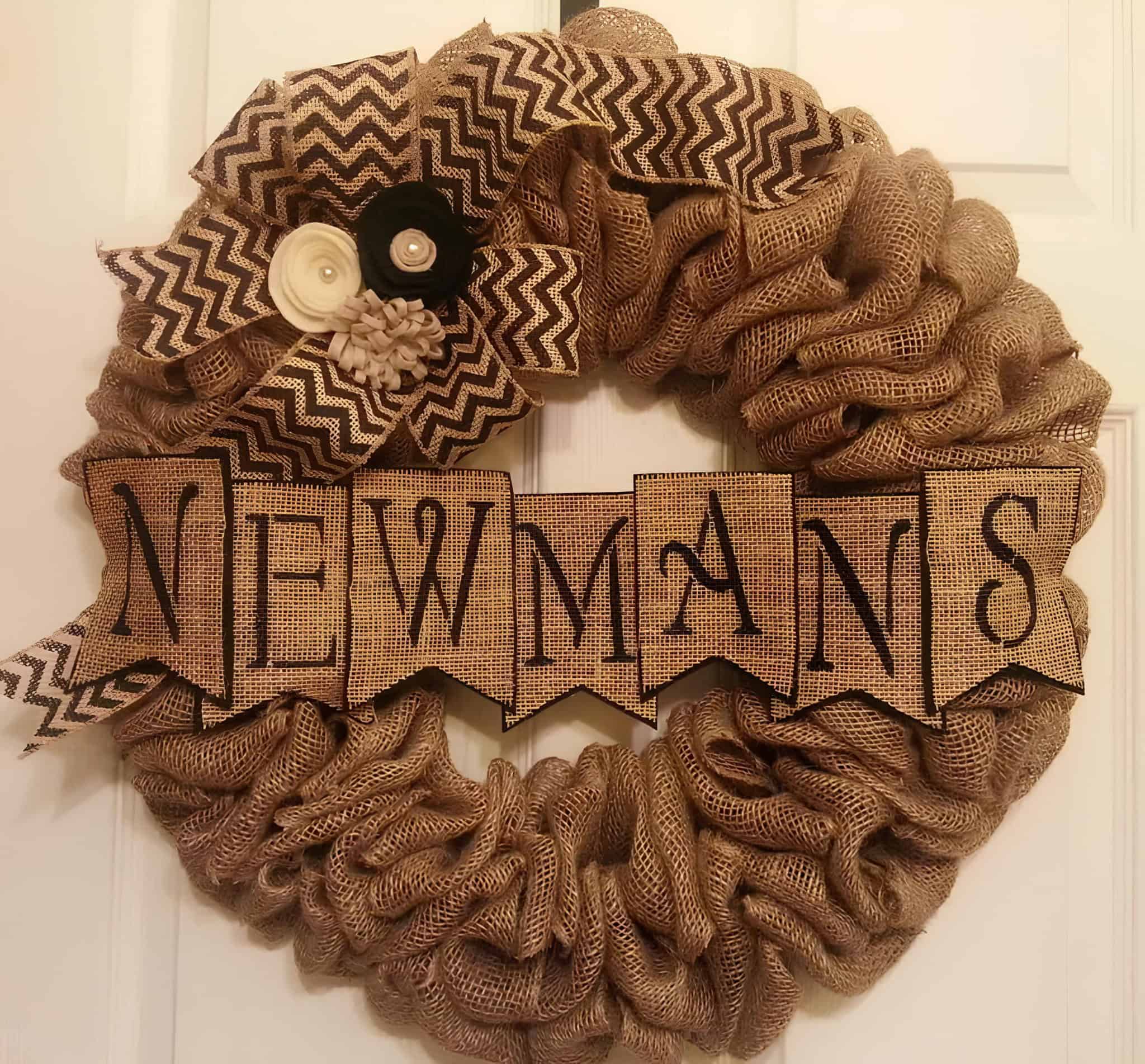 Personalized burlap wreath with family name banner and chevron bow