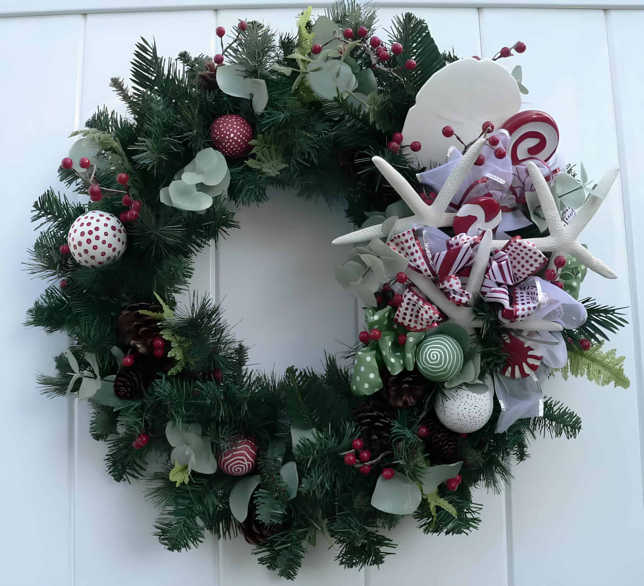 Coastal-style wreath with starfish, peppermint swirls and red berries