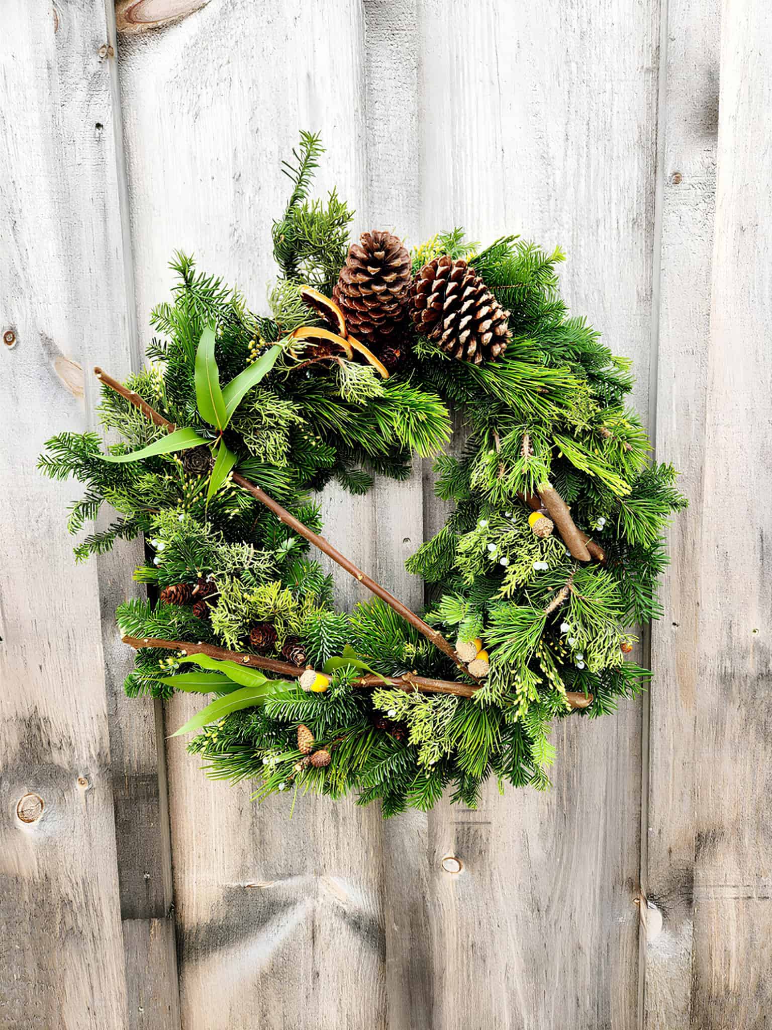 Rustic Christmas wreath made of pine branches, cones and twigs