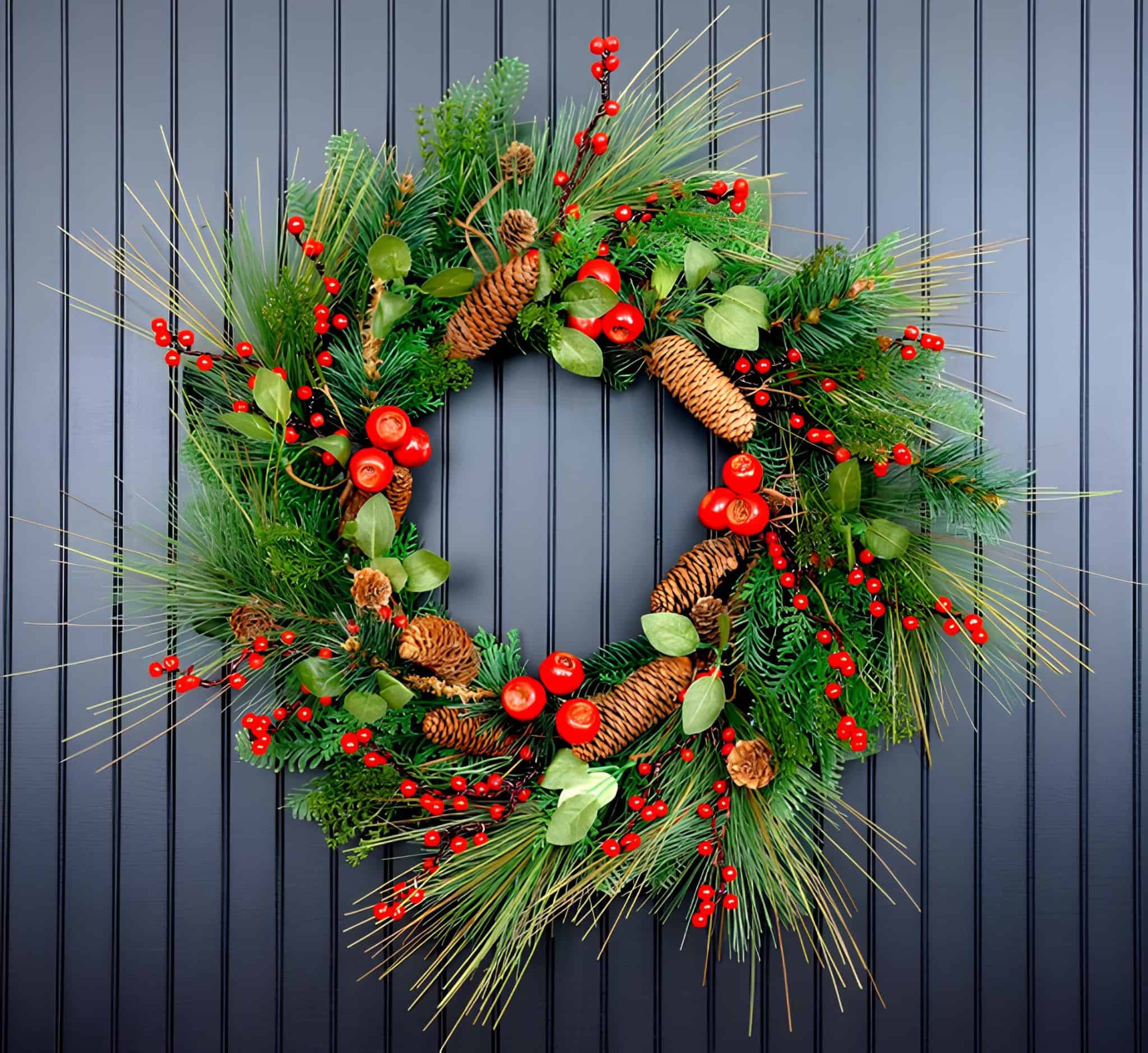 Vibrant pine wreath with red berries, cones and natural greenery