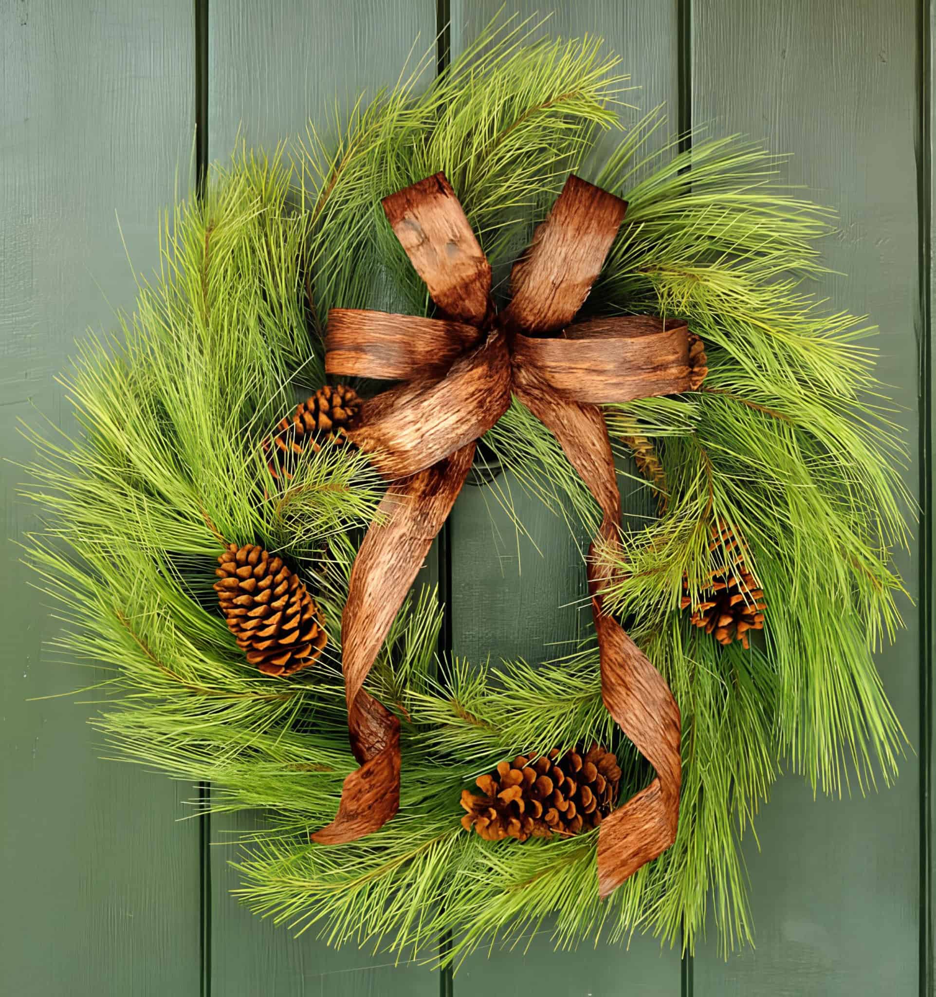 Natural evergreen Christmas wreath with pinecones and a rustic brown bow