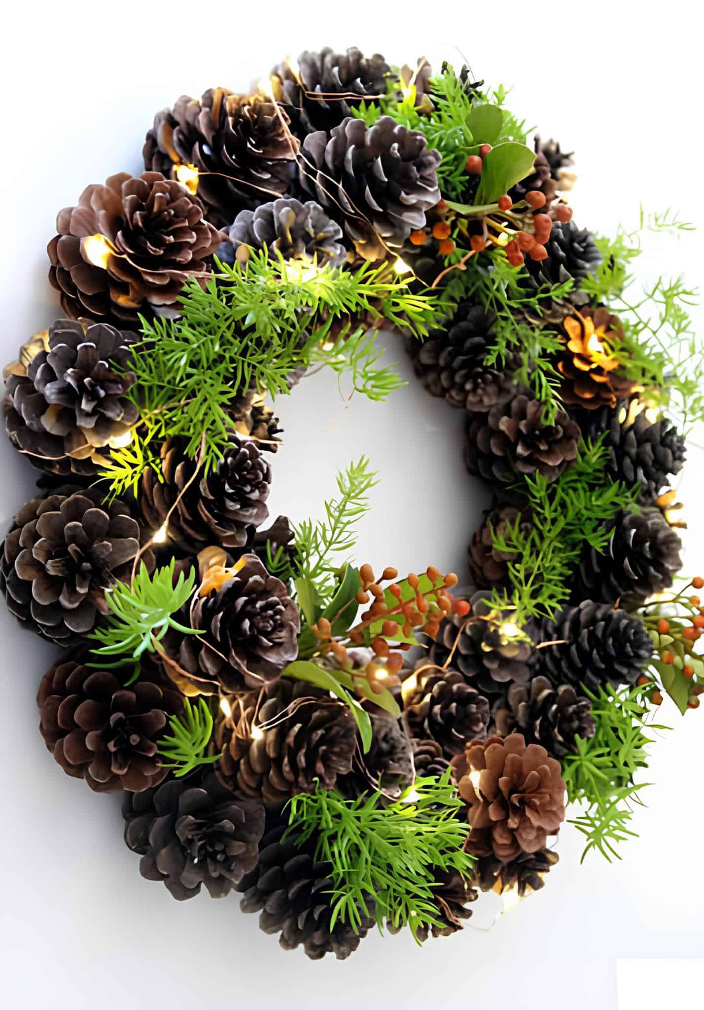 Pinecone Christmas wreath with LED lights, greenery, and berries