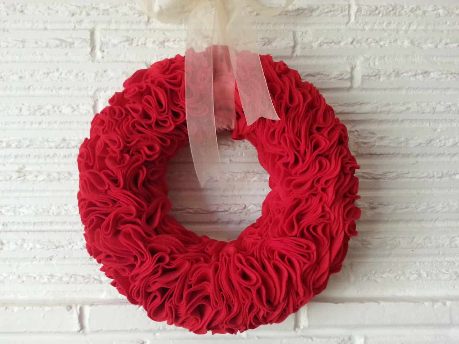 Red ruffle Christmas wreath with white bow