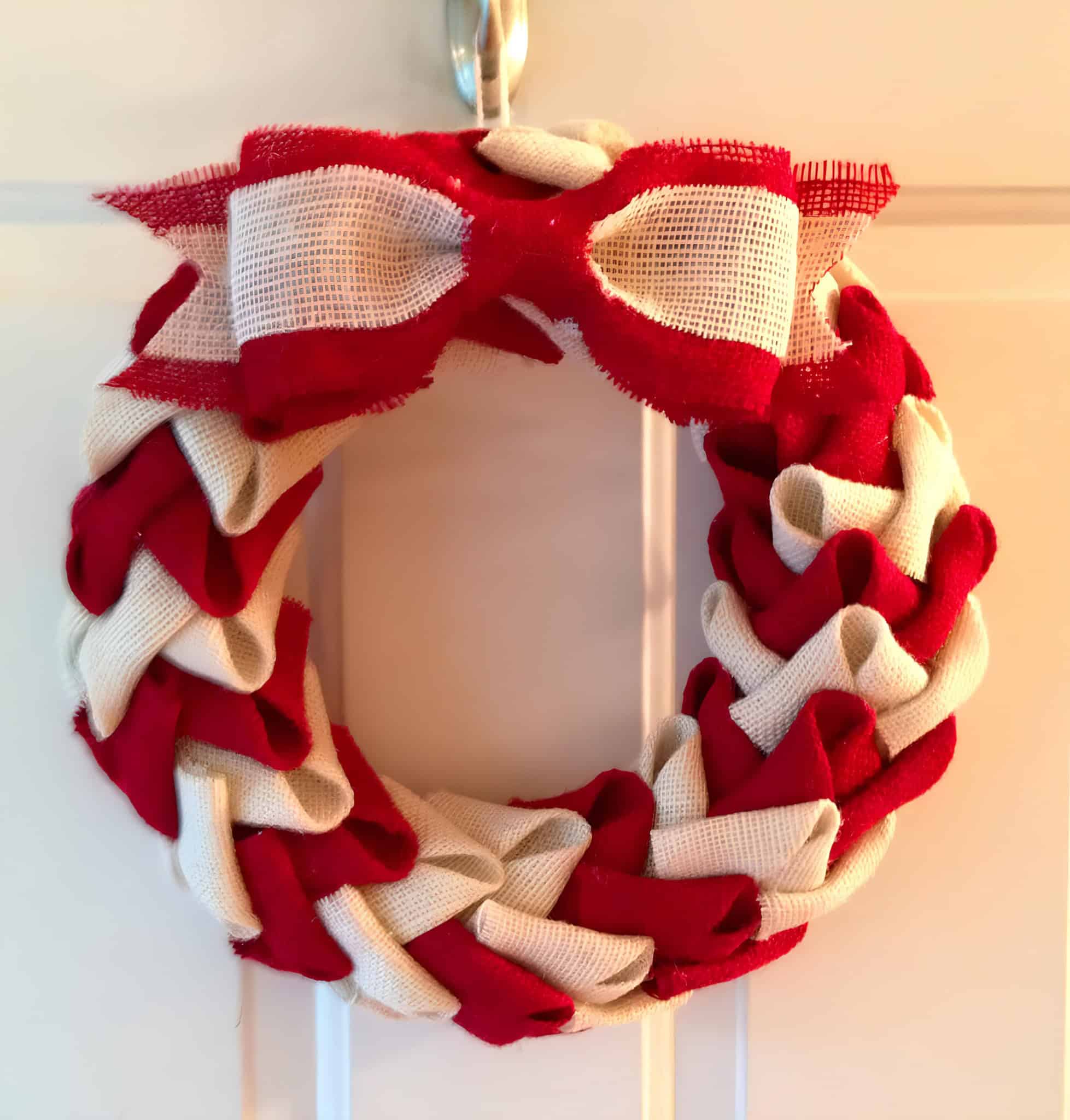 Braided red and white burlap Christmas wreath with bow