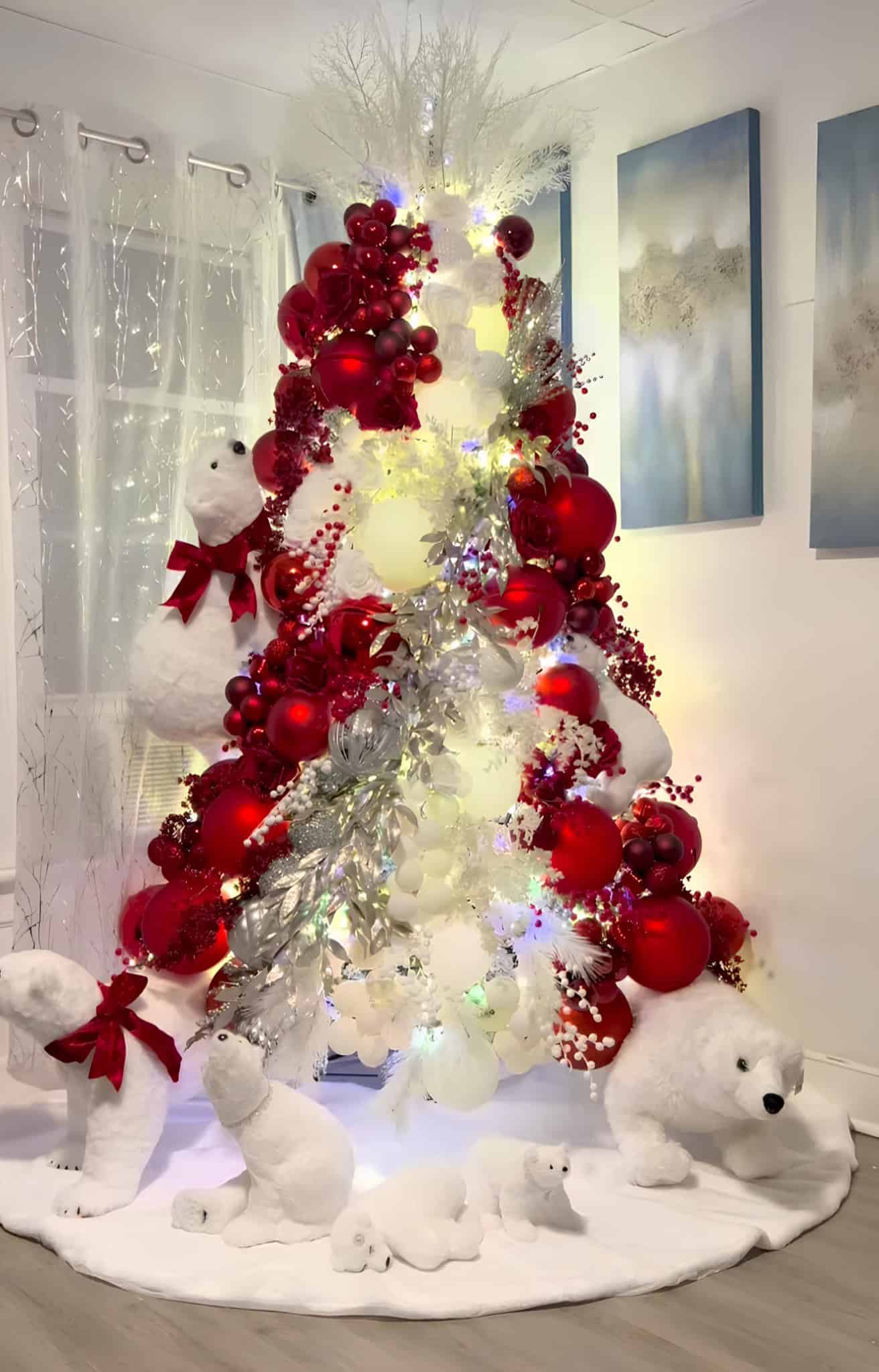 Red and white Christmas tree with polar bear decorations and glowing ornaments