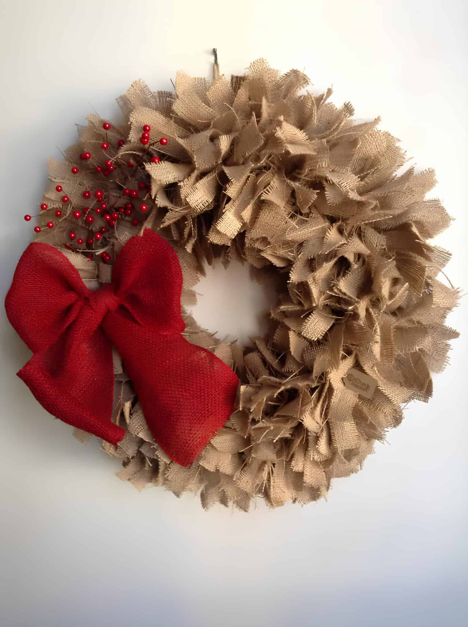 Rustic rag burlap Christmas wreath with red bow and red berries