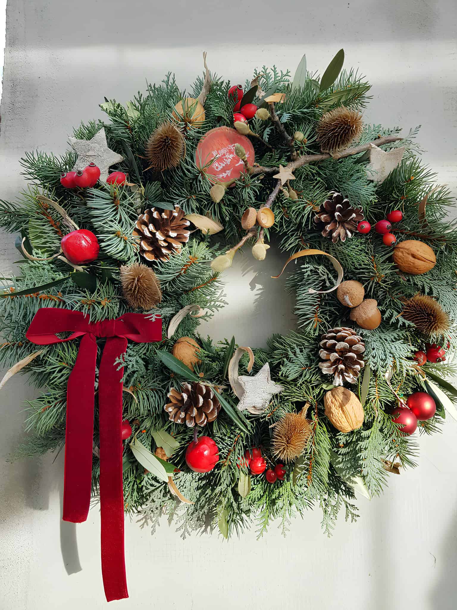 Rustic pinecone wreath with forest greenery and natural lichen