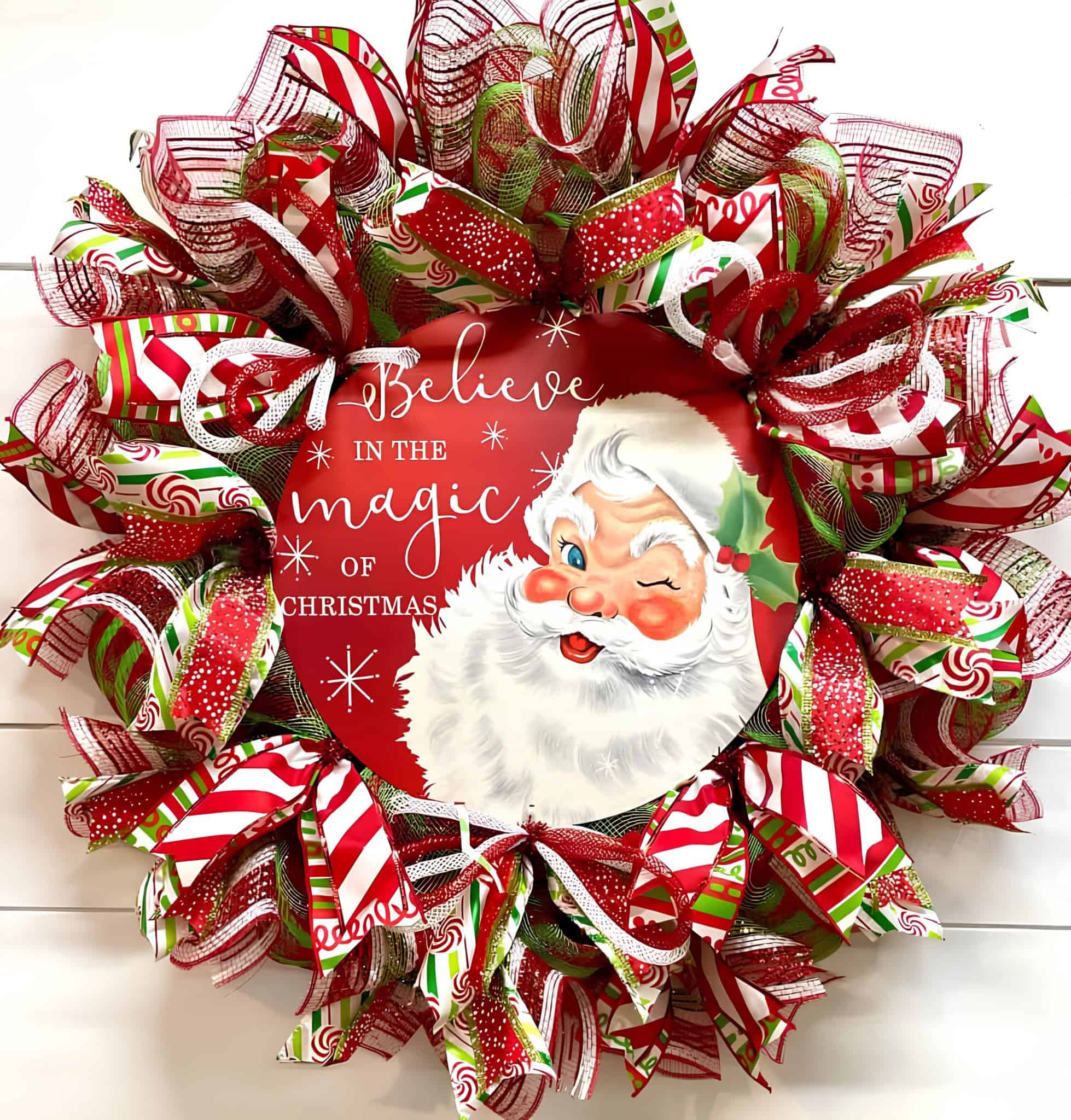 Ribbon-packed Santa wreath with Believe in the Magic sign