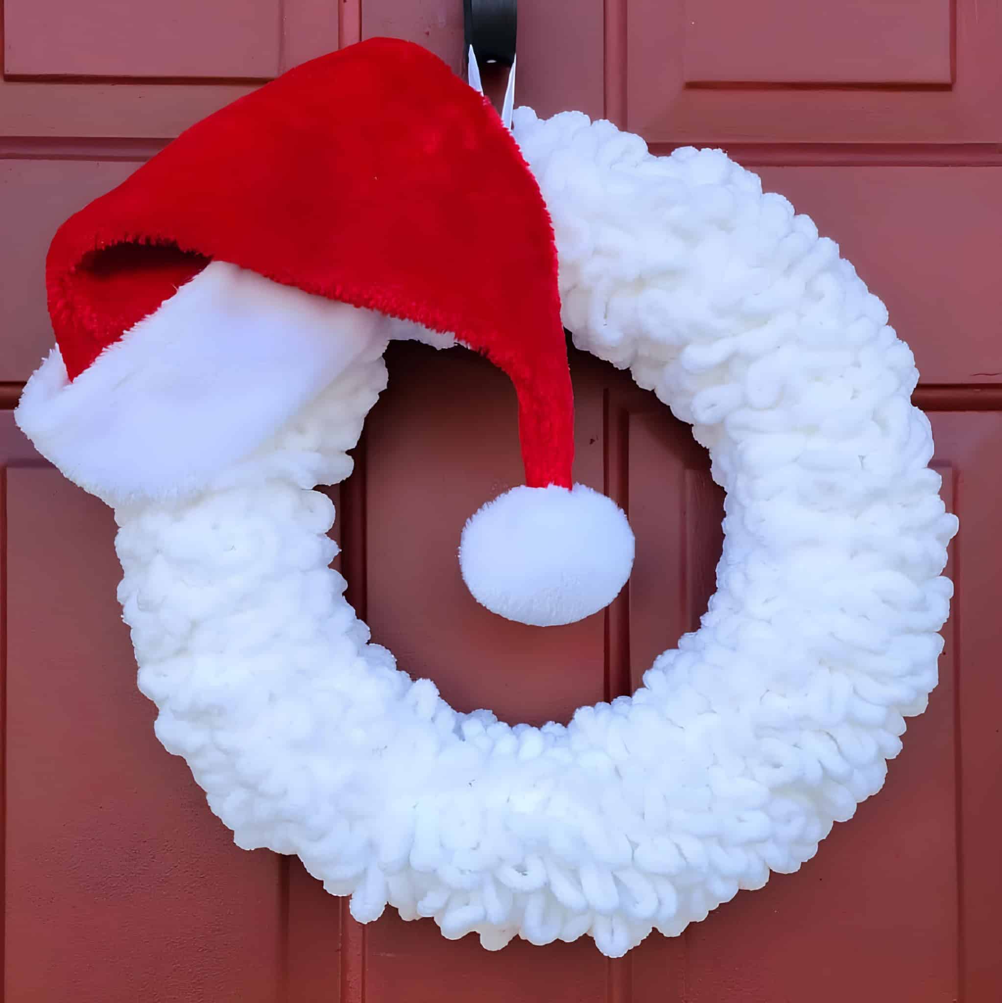 Minimal Santa wreath with soft white yarn and red Santa hat