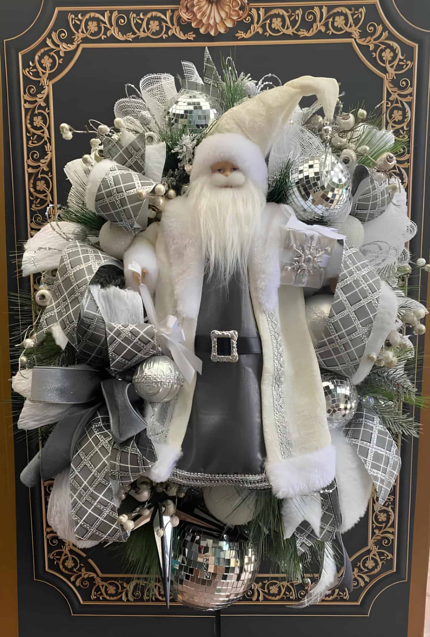 Elegant Christmas Santa decoration with black and silver ornaments, floral accents, and festive elements, perfect for holiday interior decoration and Christmas display ideas.