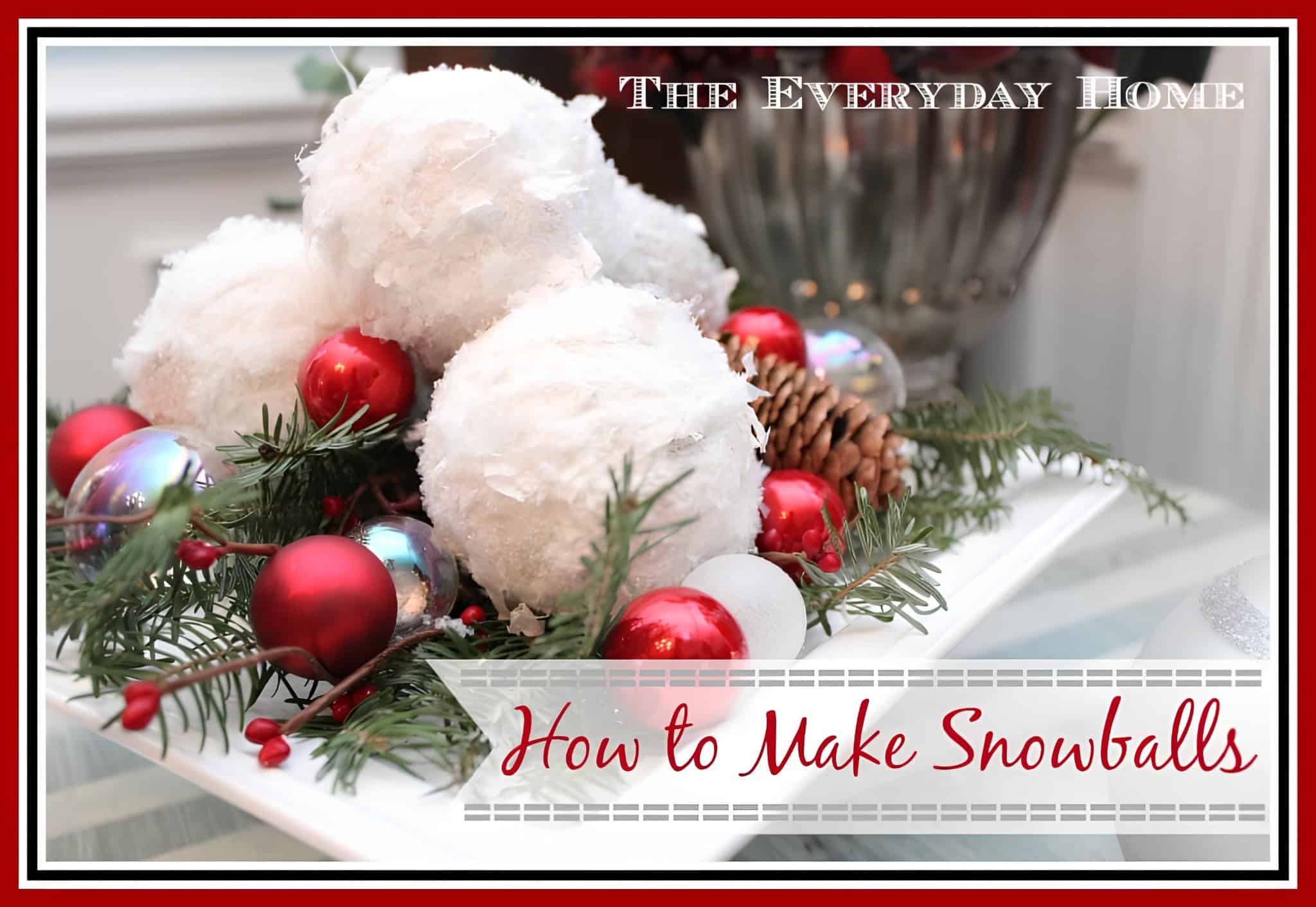 Snowball Christmas wreath centerpiece with pinecones, greenery, and red ornaments
