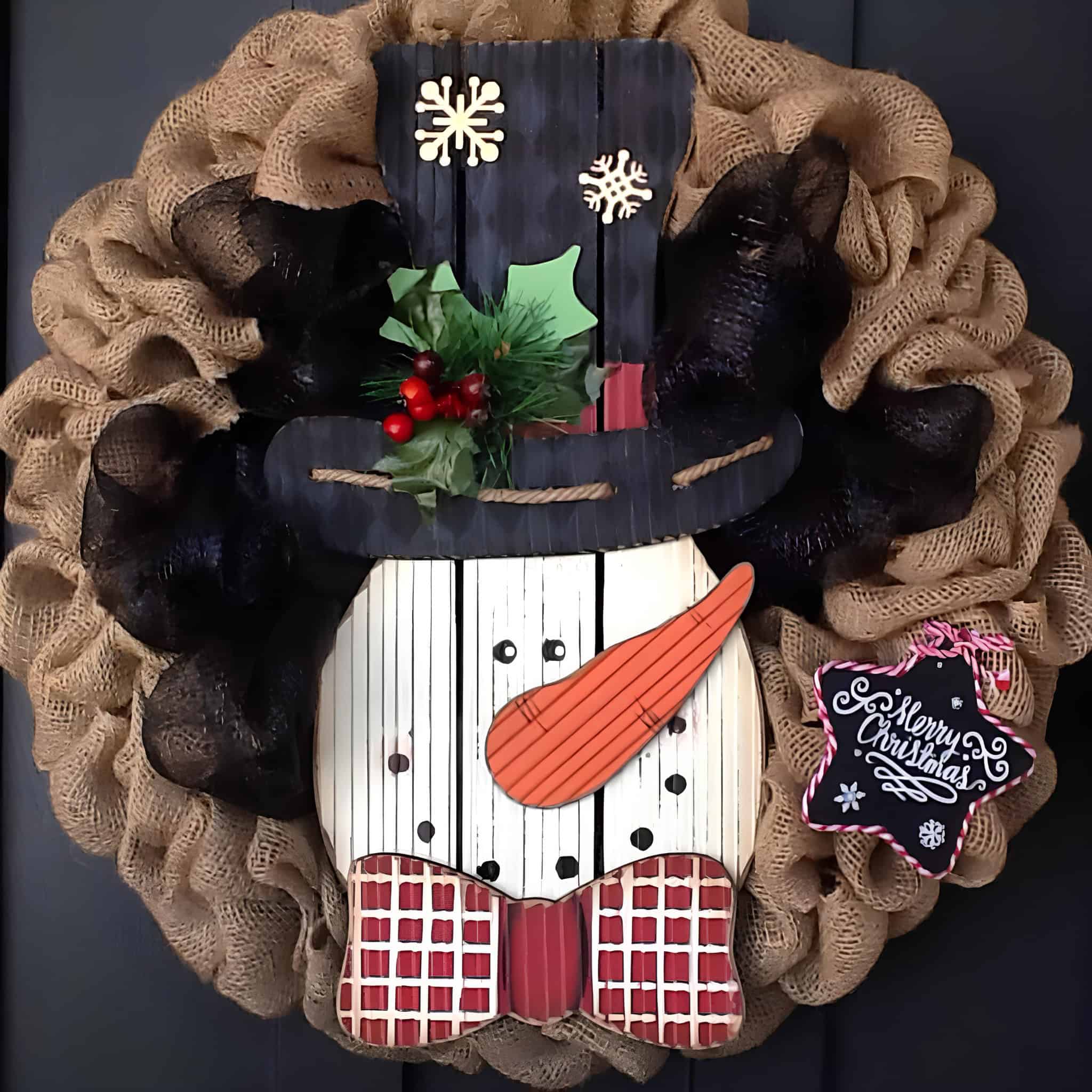 Burlap wreath with rustic snowman centerpiece, black hat and red bow tie