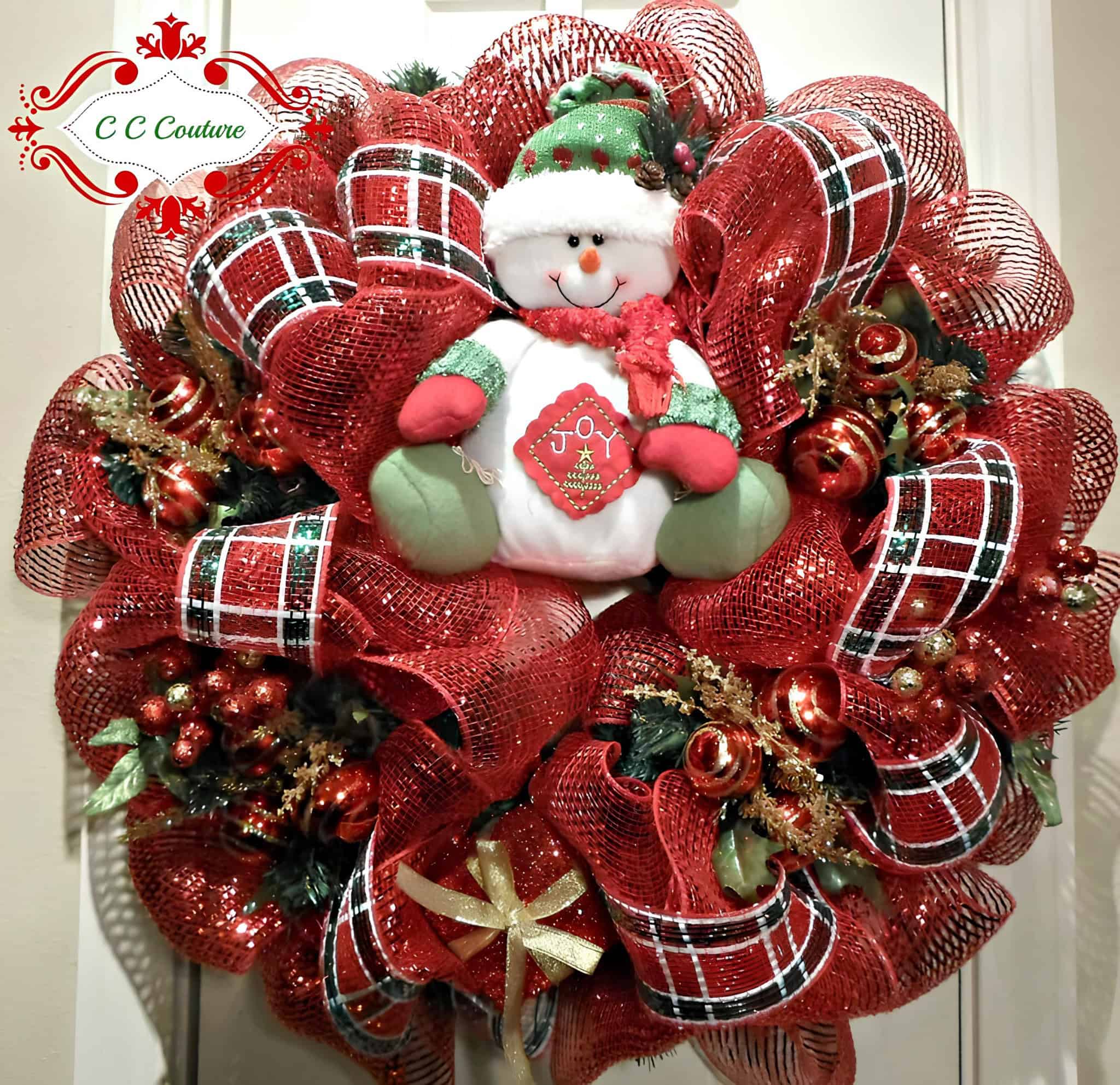 Red ribbon Christmas wreath with plush snowman and Joy sign