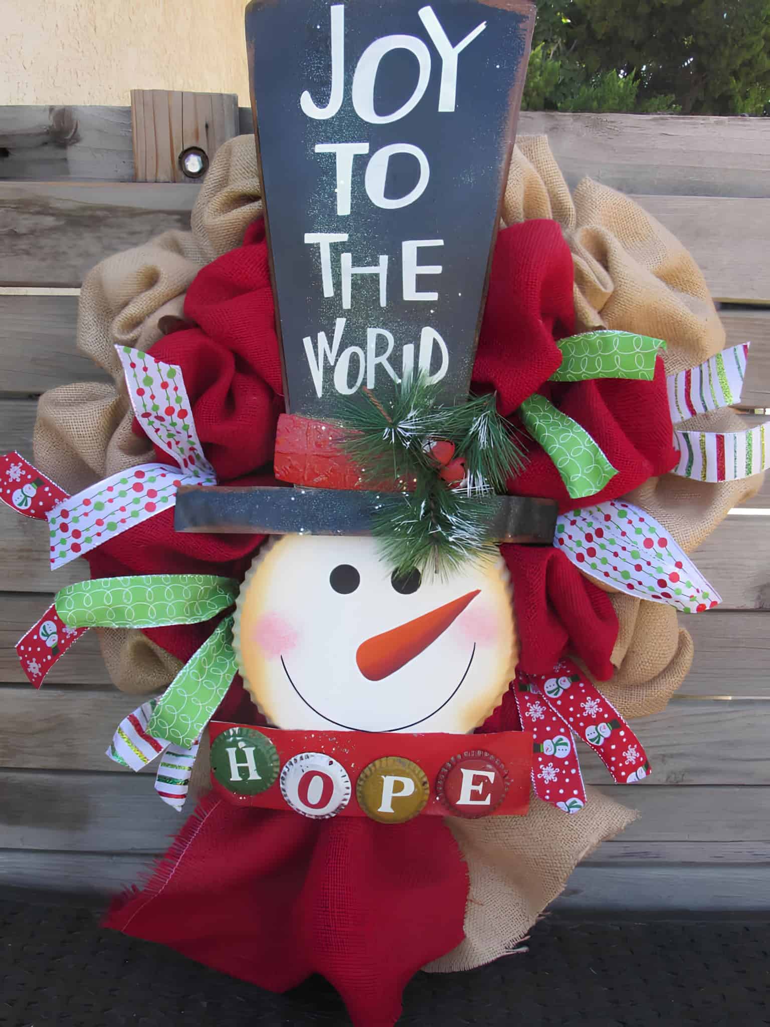 Snowman Christmas wreath with top hat, JOY TO THE WORLD sign and colorful ribbons