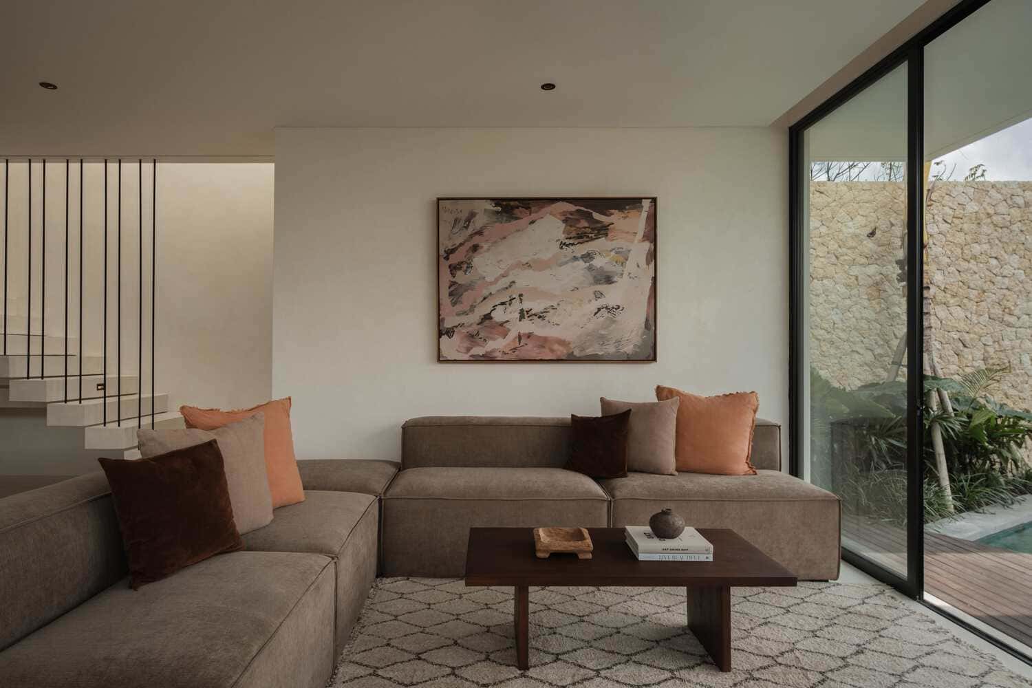 Tapa Villa Living Corner by Studio Tanama Tapa Villa by Studio Tanama living room with sectional sofa and art in Bali, Indonesia