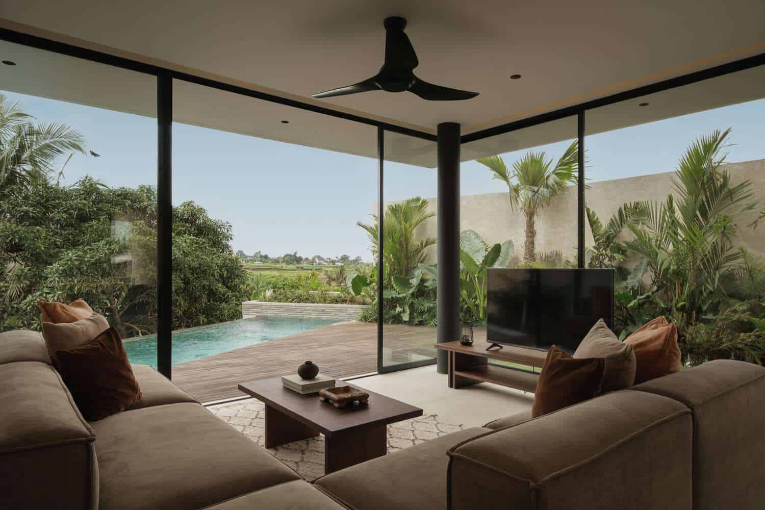 Tapa Villa Living to Pool View by Studio Tanama Tapa Villa by Studio Tanama living room opening to pool and tropical garden in Bali, Indonesia