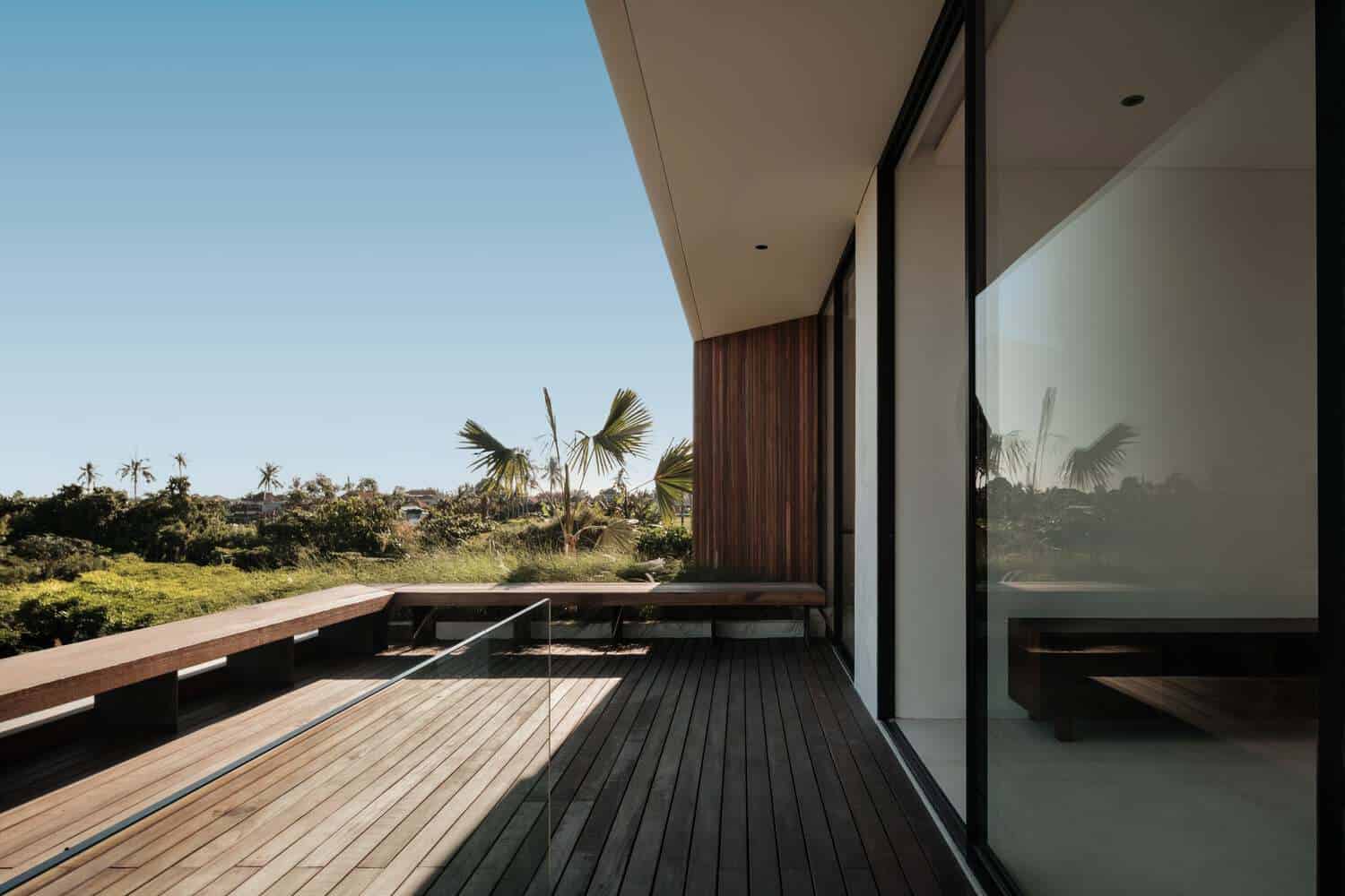 Tapa Villa Terrace View by Studio Tanama Tapa Villa by Studio Tanama terrace with wooden decking and tropical landscape in Bali, Indonesia