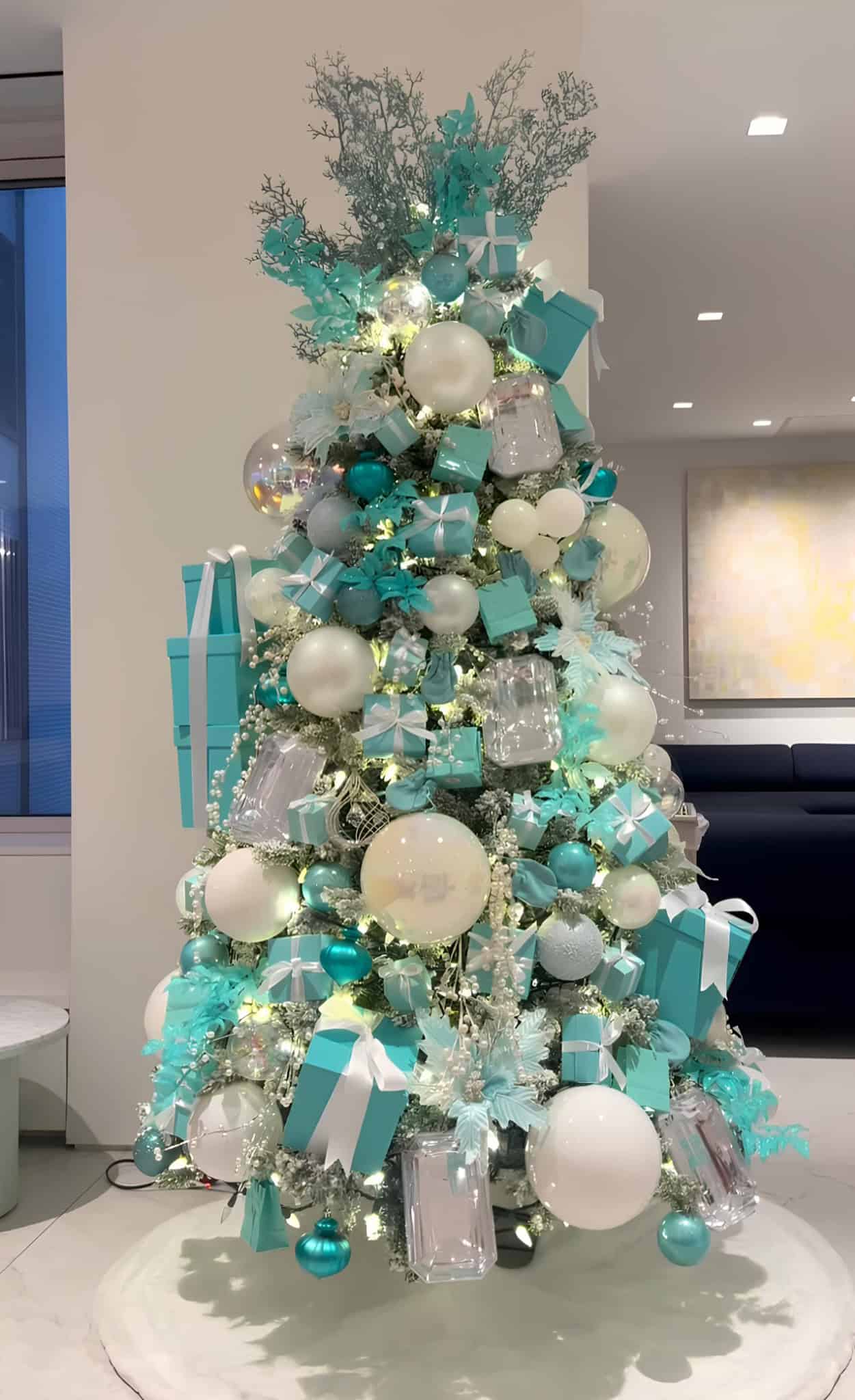 Tiffany blue and white Christmas tree with gift boxes, ornaments, and elegant lights
