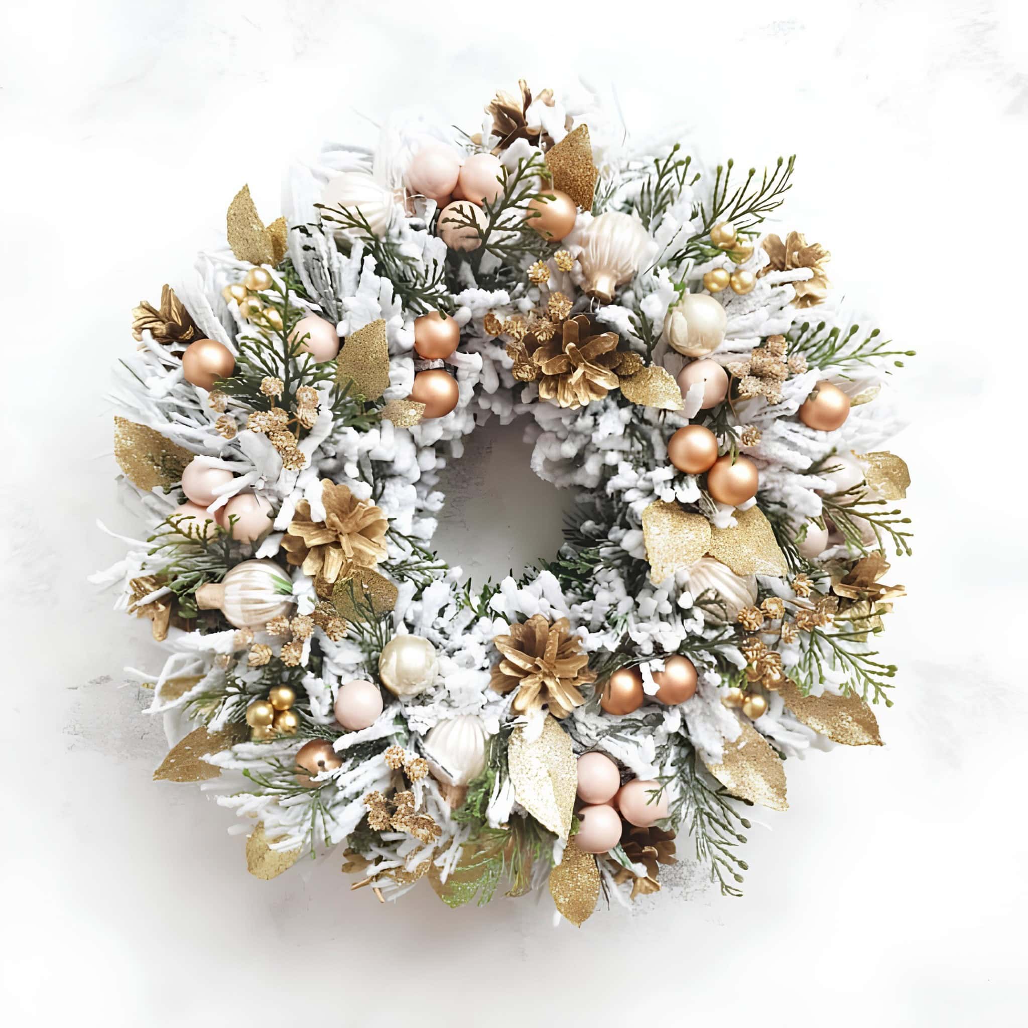 White frosted Christmas wreath with gold and blush ornaments