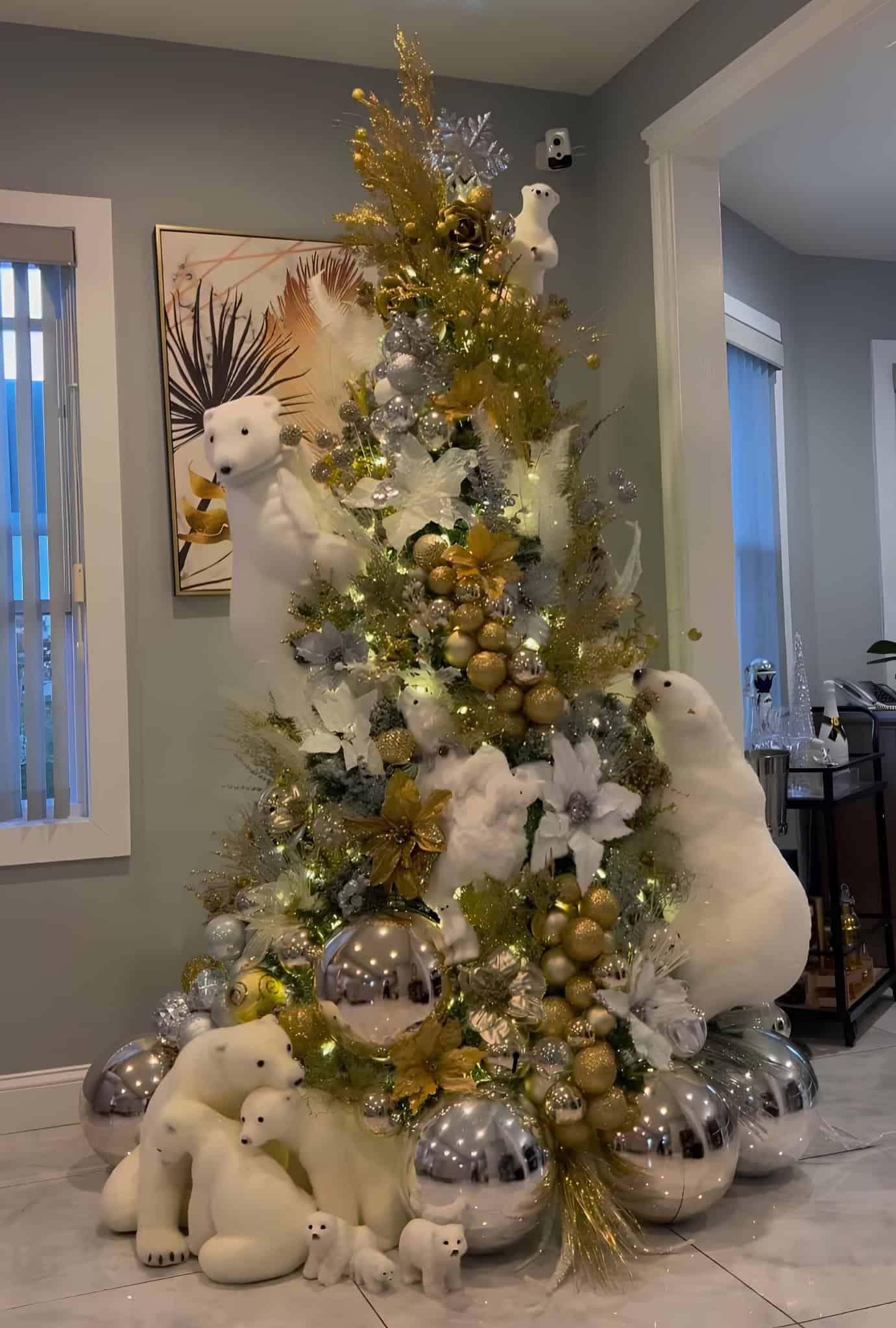 White and gold Christmas tree with polar bear decorations and oversized ornaments