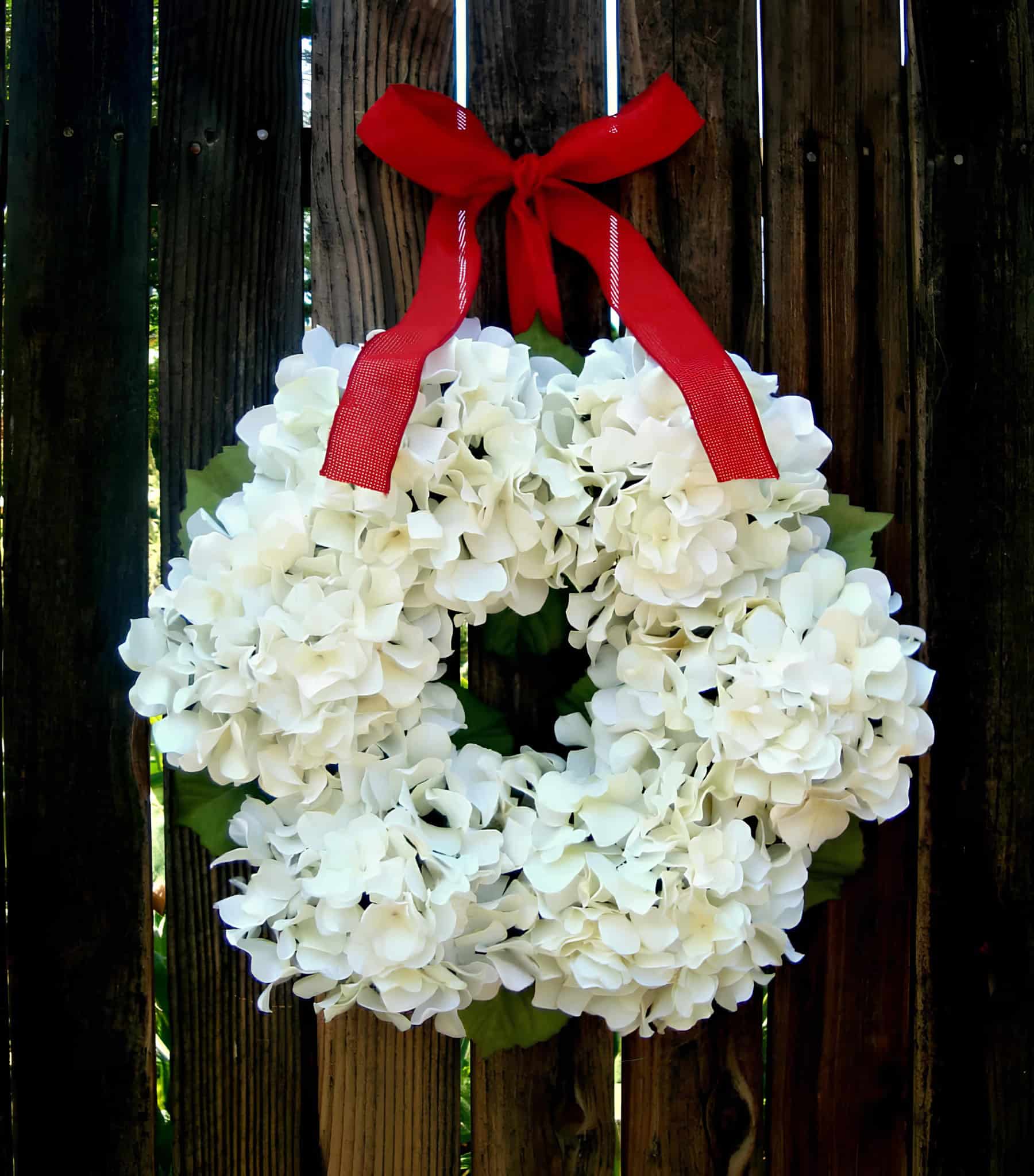 White hydrangea flower Christmas wreath with a red ribbon