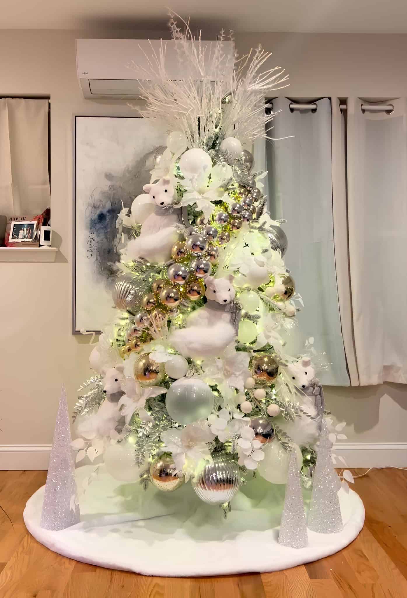 White and silver Christmas tree with polar bear plush toys and shiny baubles
