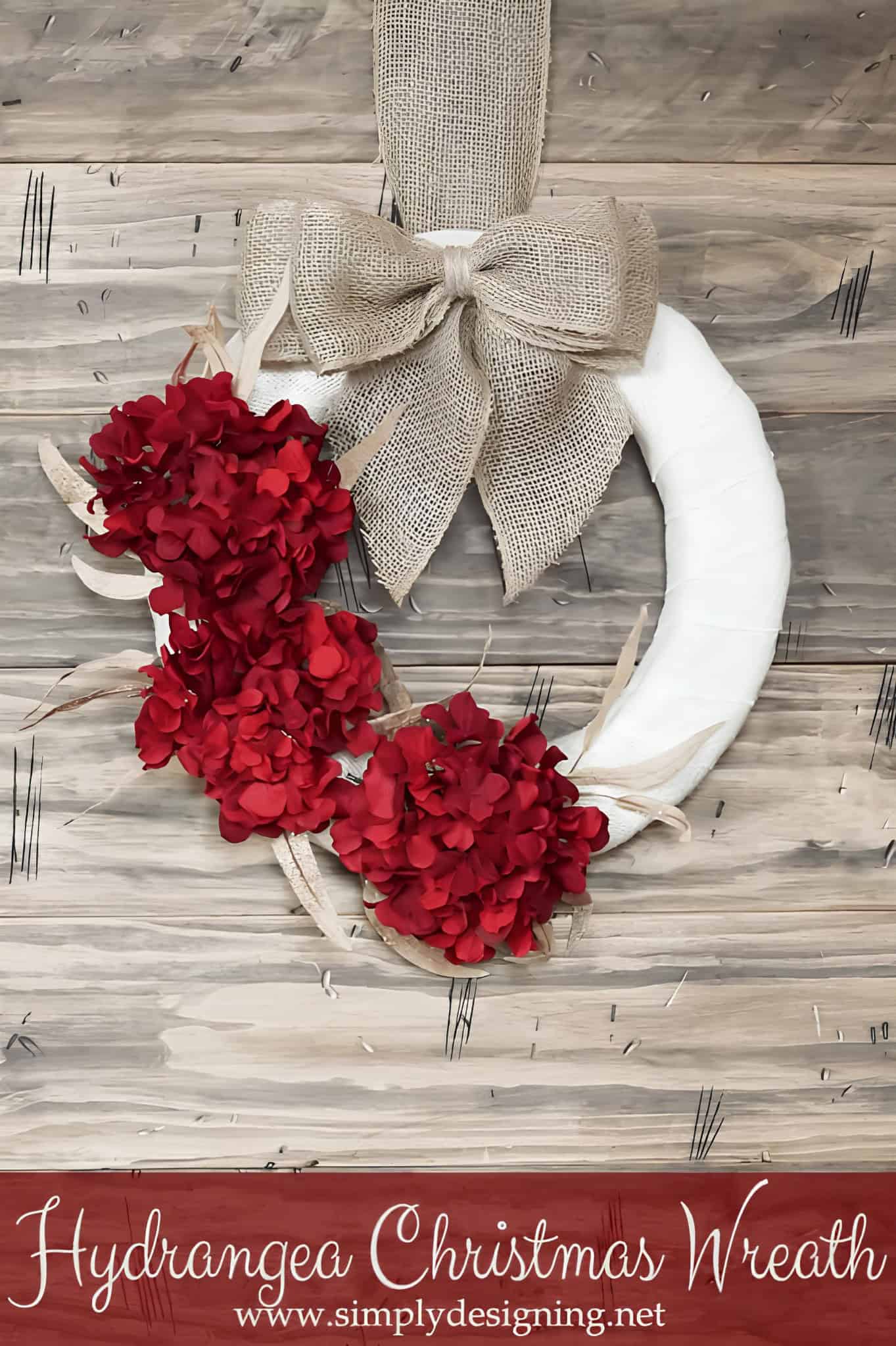 White Christmas wreath with a burlap bow and red hydrangea flowers